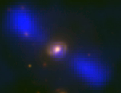 Galaxy J1649+2635 in two spectra. The blue blobs are radio signals produced by jets pour out of the galactic core. The spiral yellow is visible light of the galaxy itself. Source: Mao et al., NRAO/AUI/NSF, Sloan Digital Sky Survey