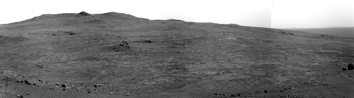 This flat patch of ground is actually an impact crater. In the foreground you can see the thin ring of stones that mark Spirit of St. Louis Crater's rim and off-center in the midground there's an unusual mound of stones. Credit: Nasa/JPL-Caltech from USGS