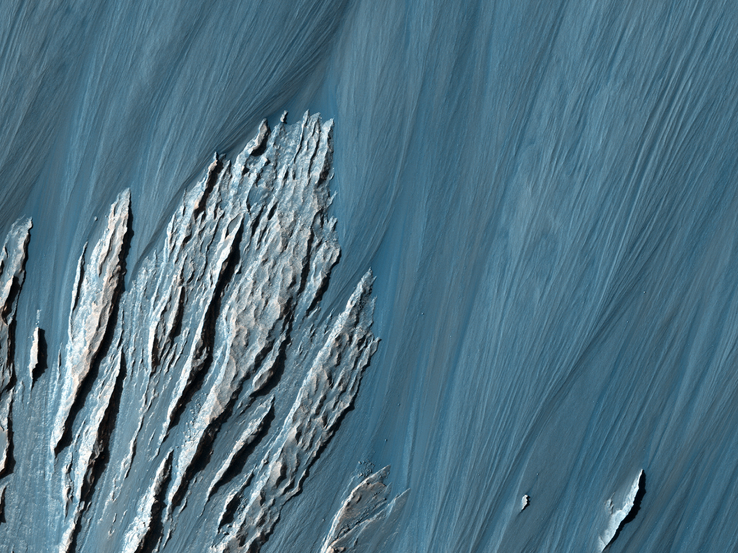 Landslides along the cliffs of Hebes Chasma uncovered rock layers which scientists can use to study Mars' geological history. Credit: Nasa/JPL-Caltech/University of Arizona