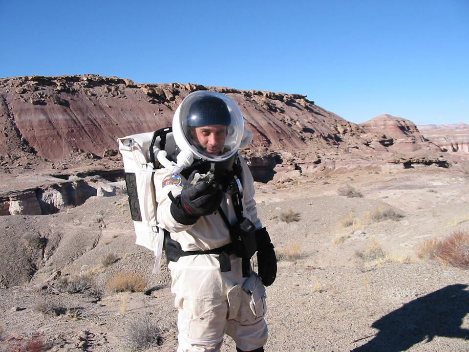 Mars Society founder Robert Zubrin in 2002 holding a dinosaur fossil found while simulating the geological exploration of Mars. Credit: Mars Society