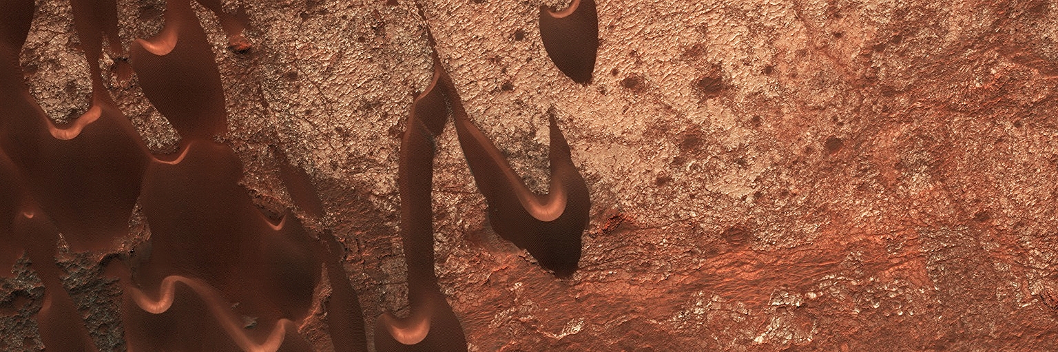 Nili Patera is an ancient martian volcano with a 2-kilometer deep caldera. Wind-swept dunes constantly shift across the surface of the caldera floor as seen in this HiRise image from the Mars Reconnaissance Orbiter. It's a detail from a larger image scientists use to monitor the dune dynamics. Credit: Nasa/JPL-Caltech/University of Arizona