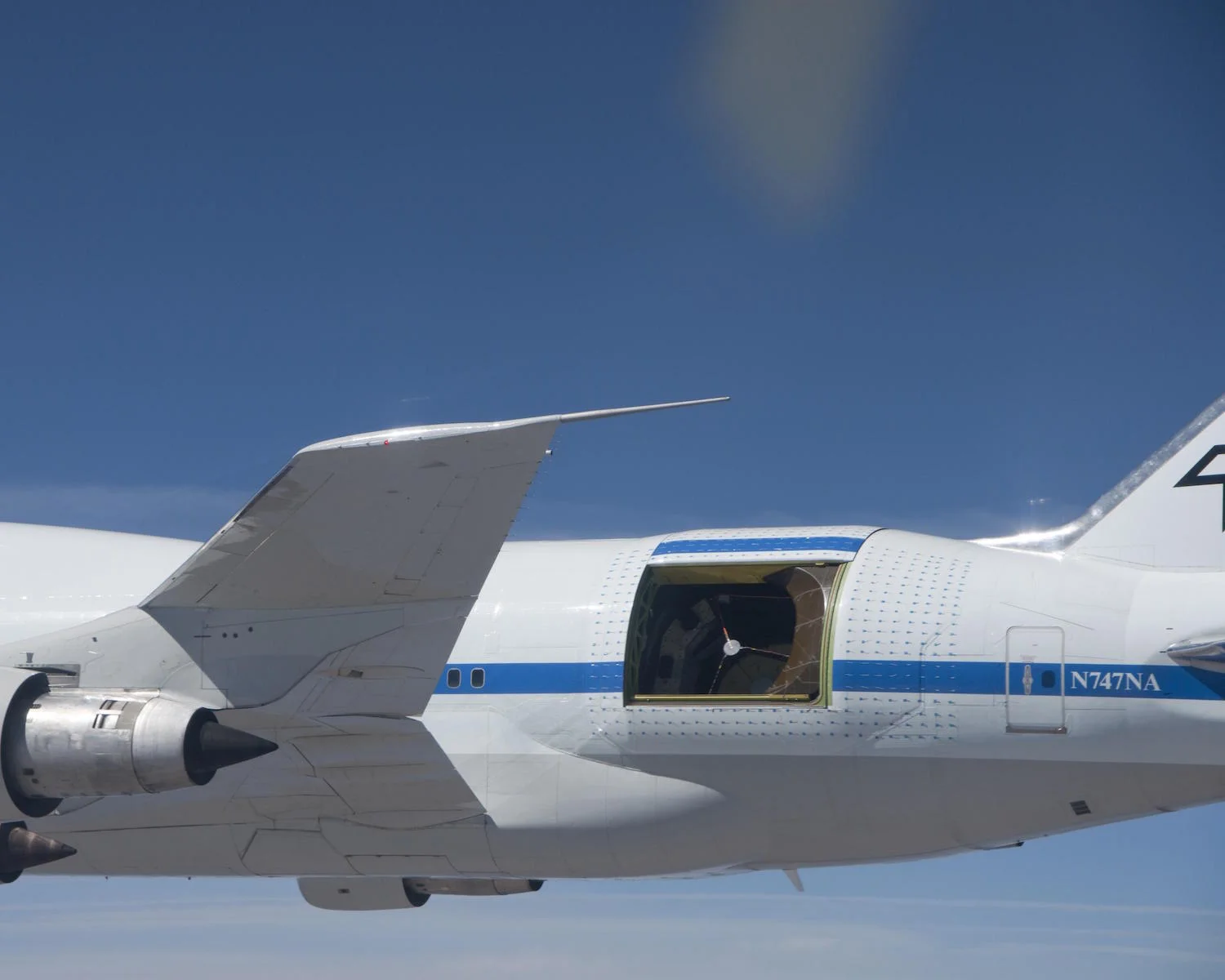 Do you feel a draft? Nasa's modified Boeing 747 carries a 100-inch infrared telescope to altitudes 10,000 feet higher than commercial aircraft fly. Above the light-absorbing moisture of the lower atmosphere the flying observatory supports research no ground-based telescope can do. Credit: Nasa/Jim Ross