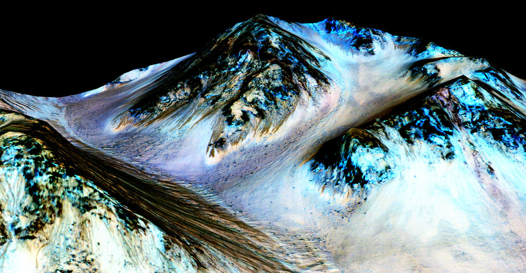 This exaggerated false-color image shows the dark streaks of recurring slope lineae on the walls of Hale Crater. Credit: Nasa/JPL-Caltech/University of Arizona 