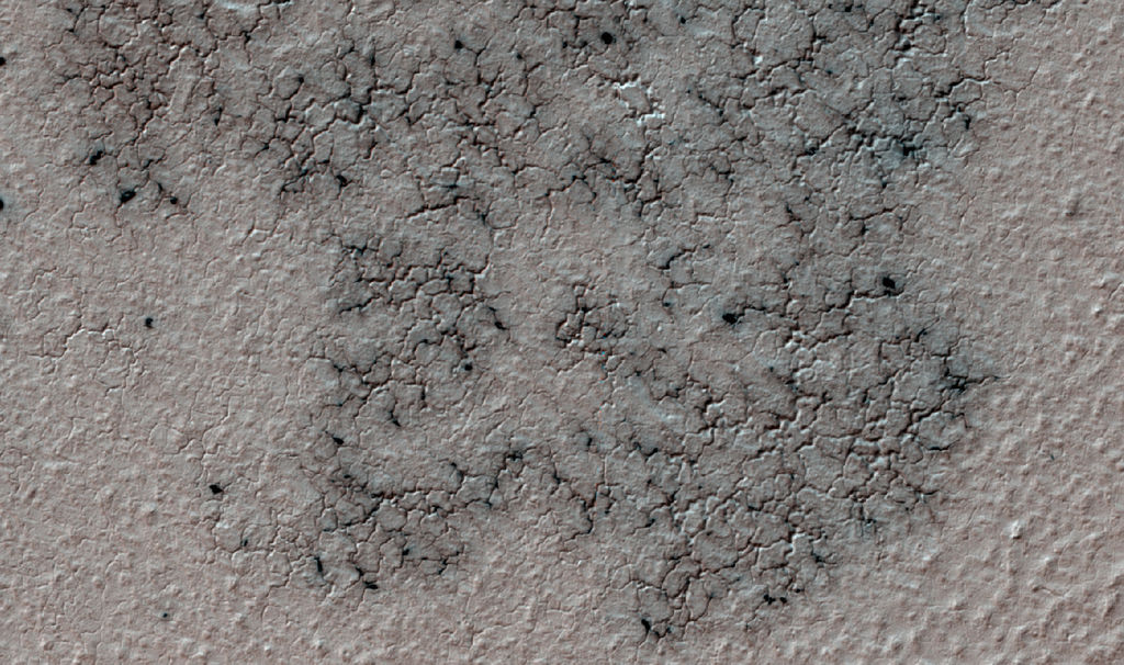 "Spiders" appear every spring in the southern hemisphere of Mars. They form as dust is blown onto the winter's frozen carbon dioxide. Once summer arrives and the carbon dioxide sublimates, the spiders disappear. Credit: Nasa/JPL-Caltech/University of Arizona