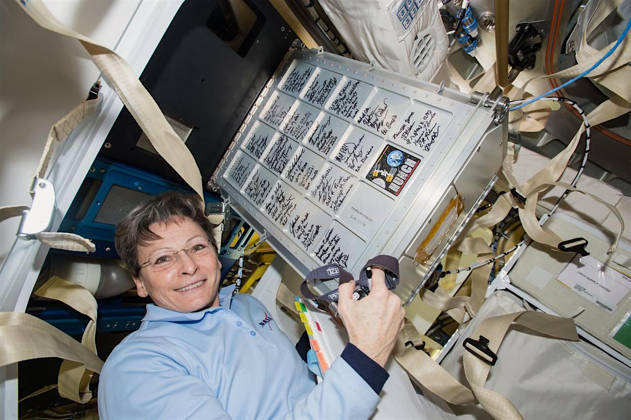 Nasa astronaut and International Space Station Commander Peggy Whitson holds a small storage locker built by high school students in the space agency's Hunch program. Credit: Nasa
