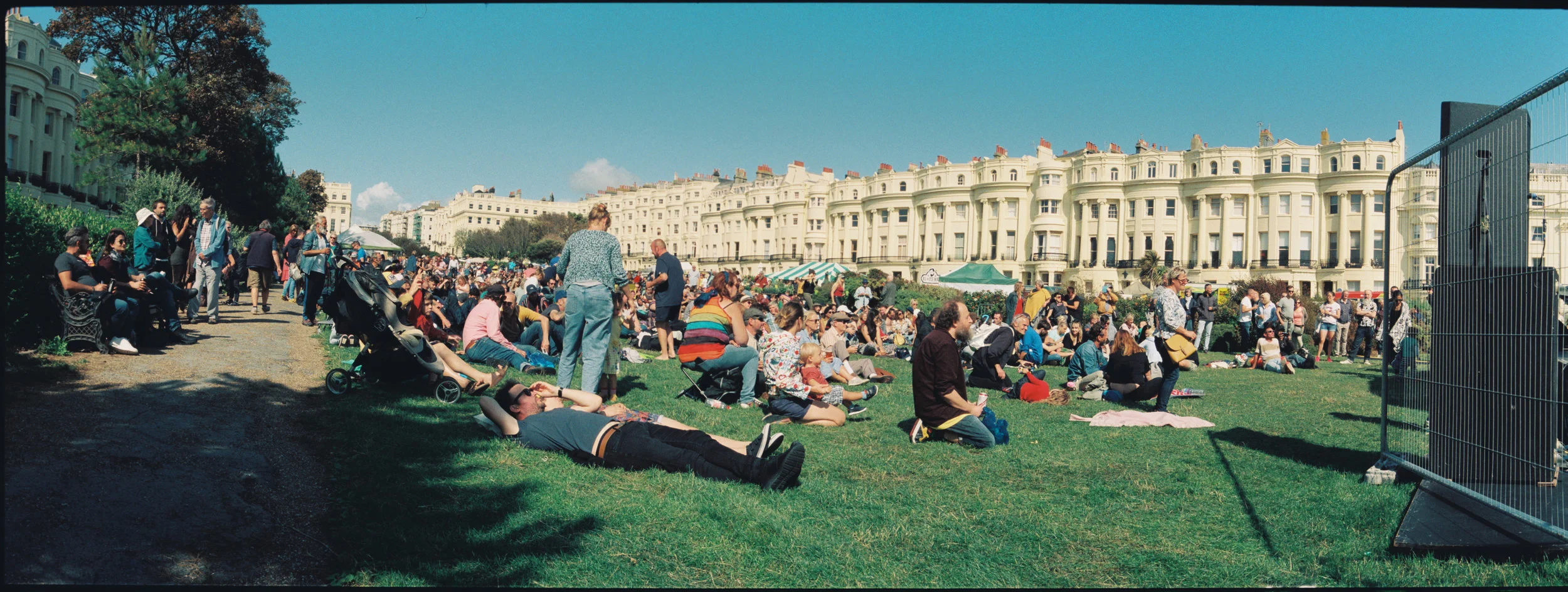 This is at the Brunswick festival in brighton, near the stage. I like the tidy houses along the back in contrast to the mess of the festival. Too much foreground space and the railing on the right doesn’t need to be there.