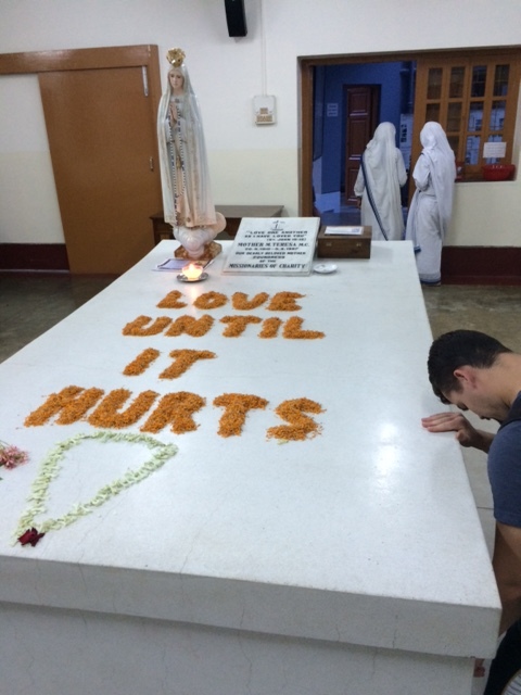 Martin, an spo missionary who went to india with me, prays beside mother teresa's tomb