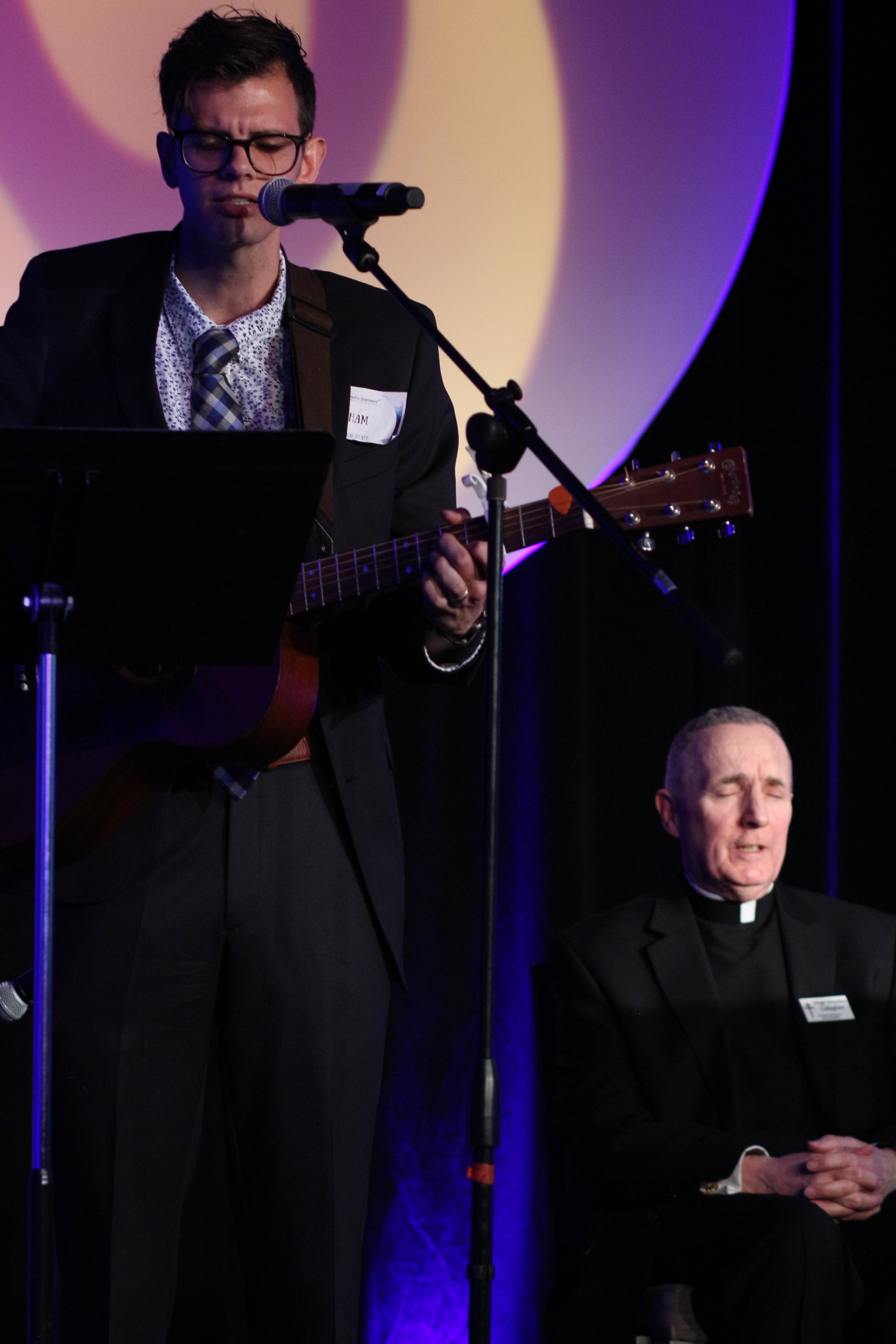 Abe gross (left) led a rendition of "Our Lady of Knock" to honor Msgr. Callaghan (right) after he was awarded the Bishop Paul Dudley Servant Leadership award.