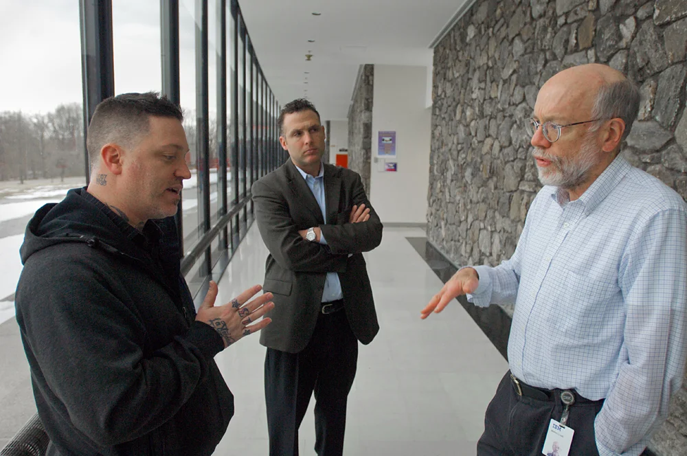 The artist Joshua Davis (left) was responsible for WATSON's visual identity; here he discusses with IBM Research's Burn Lewis how the machine will appear on TV.