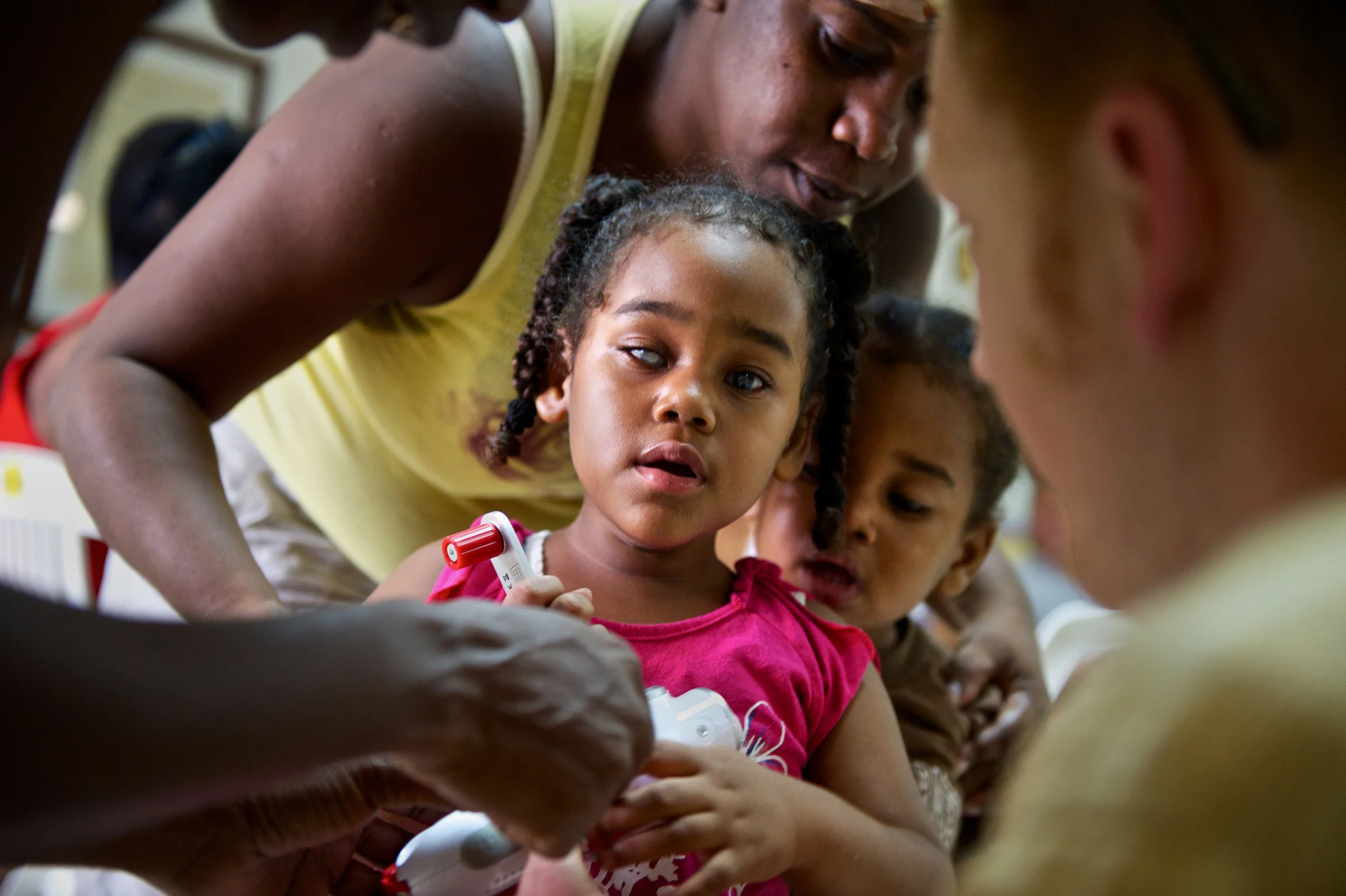 Miracle Malaki, a visually impaired student at the BCVI Summer Camp in Belize City, Belize, receives a self-powered radio from Ears to Our World.