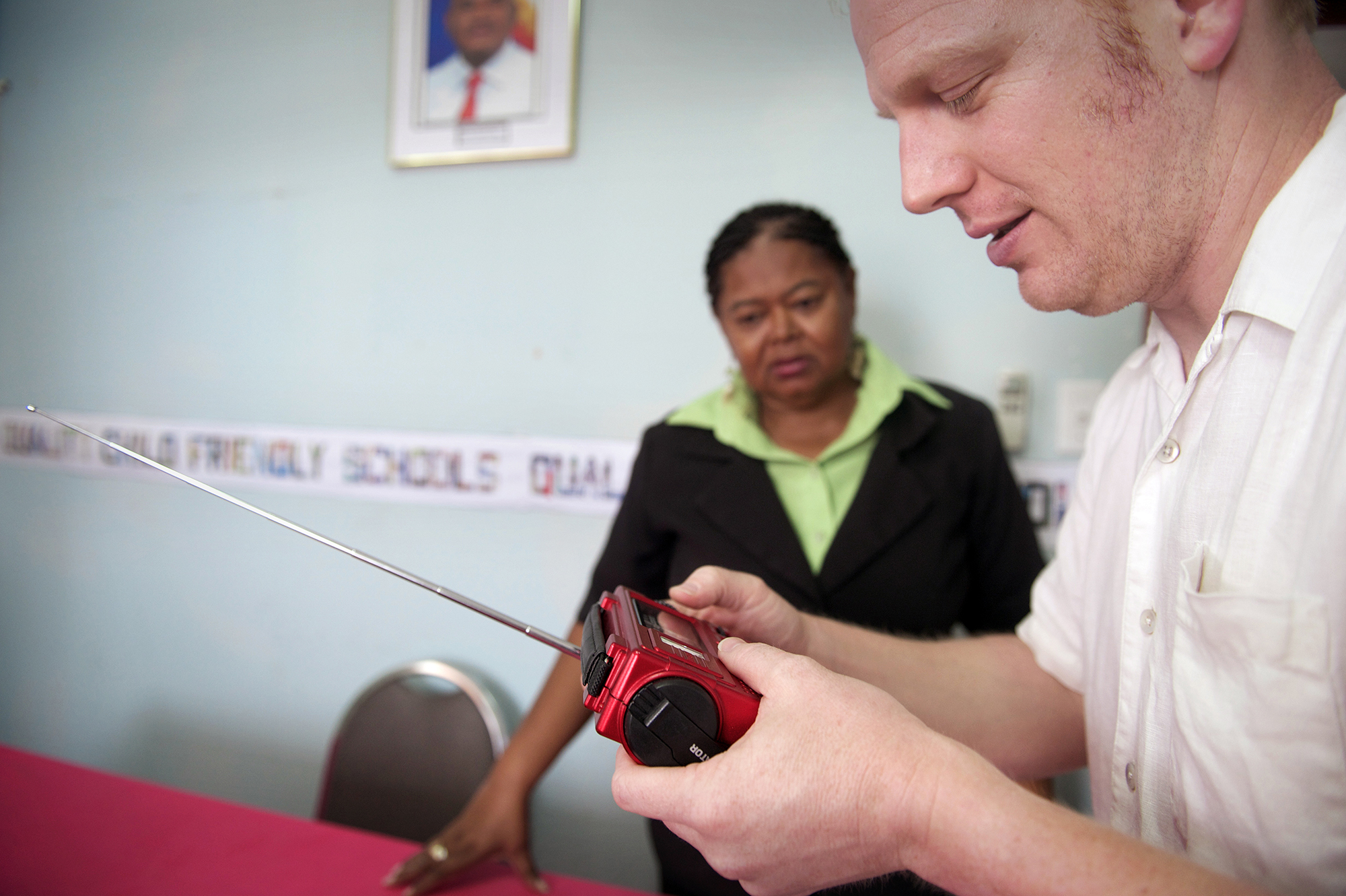 Ears to Our World founder Thomas Witherspoon demonstrates a self-powered radio at Belize Ministry of Education offices, Belize City.