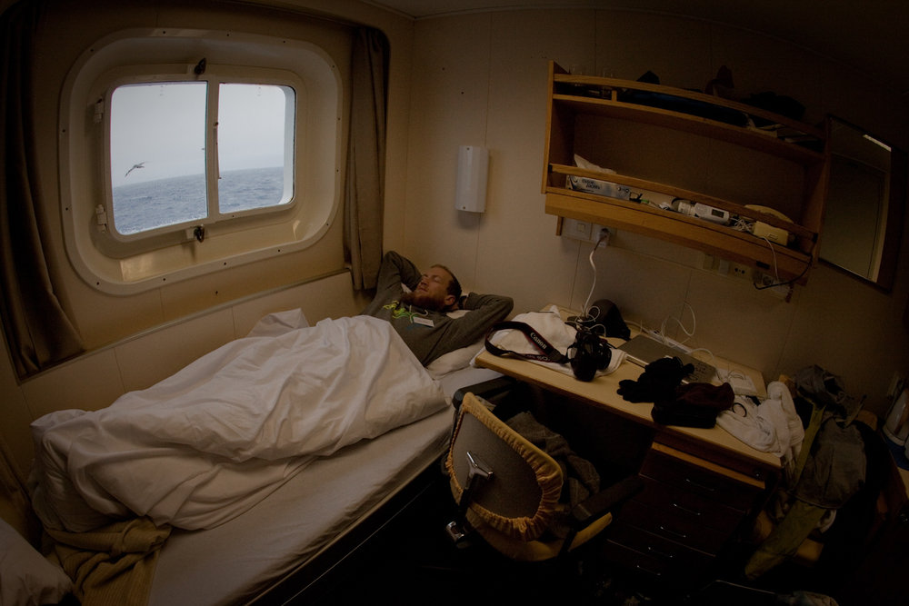 Nic in bed as an albatross soars by our window on the Drake Passage.