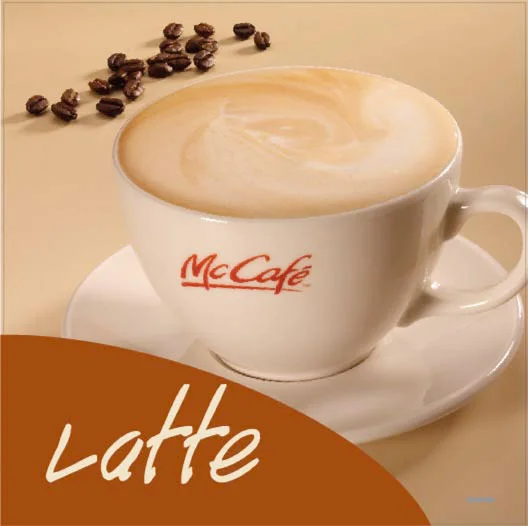 McDonald's McCafe latte menu hero sign featuring a McCafe Latte in a branded coffee mug, with coffee beans in the background