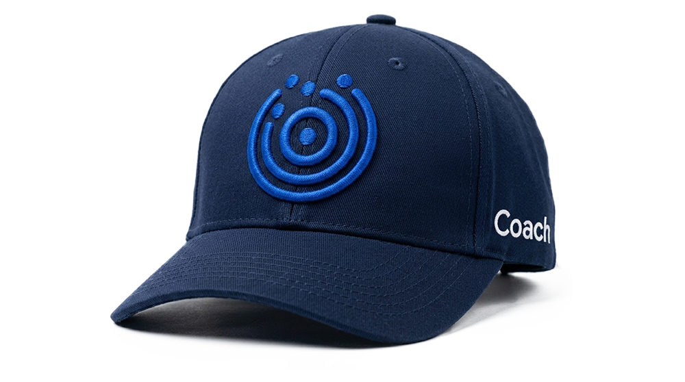 Proposed CareerClarity360 Coach Cap — A navy blue baseball cap featuring and embroidered CC360 brand-hero blue icon on the front and white 'Coach' lettering on the side