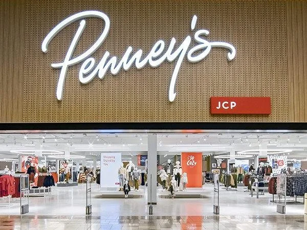 Entrance to Penney's department store with visible interior and shoppers shopping inside.