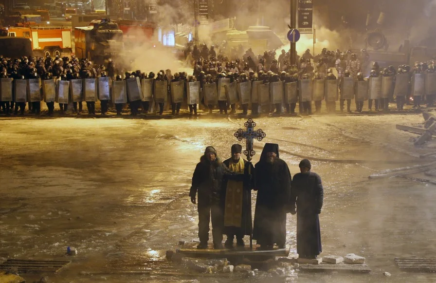 An Associated Press photo of priests intervening in riots in Kiev in January of 2014. ( via Huffington Post )