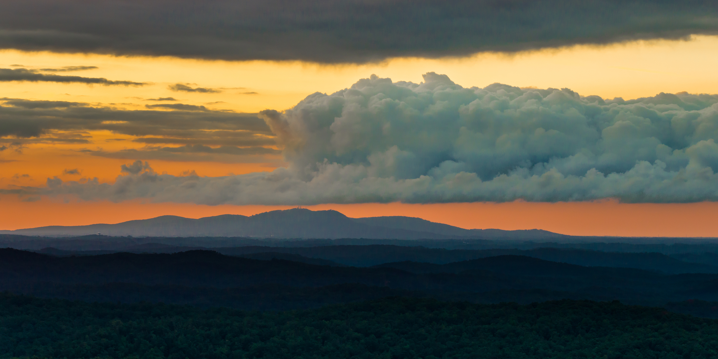 blue mountains with yellow and orange sky