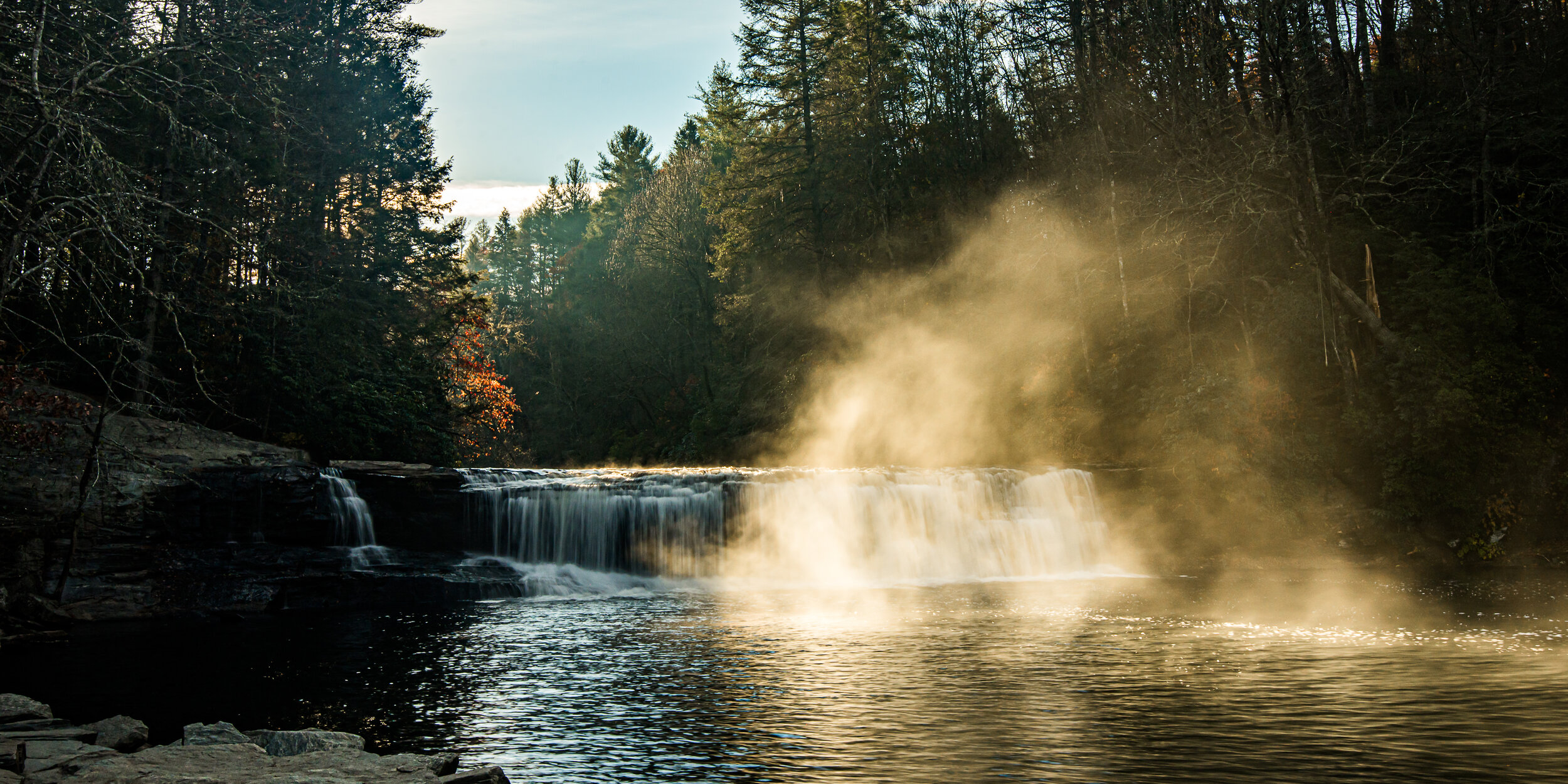 sun lights up rising mist below Hooker Falls