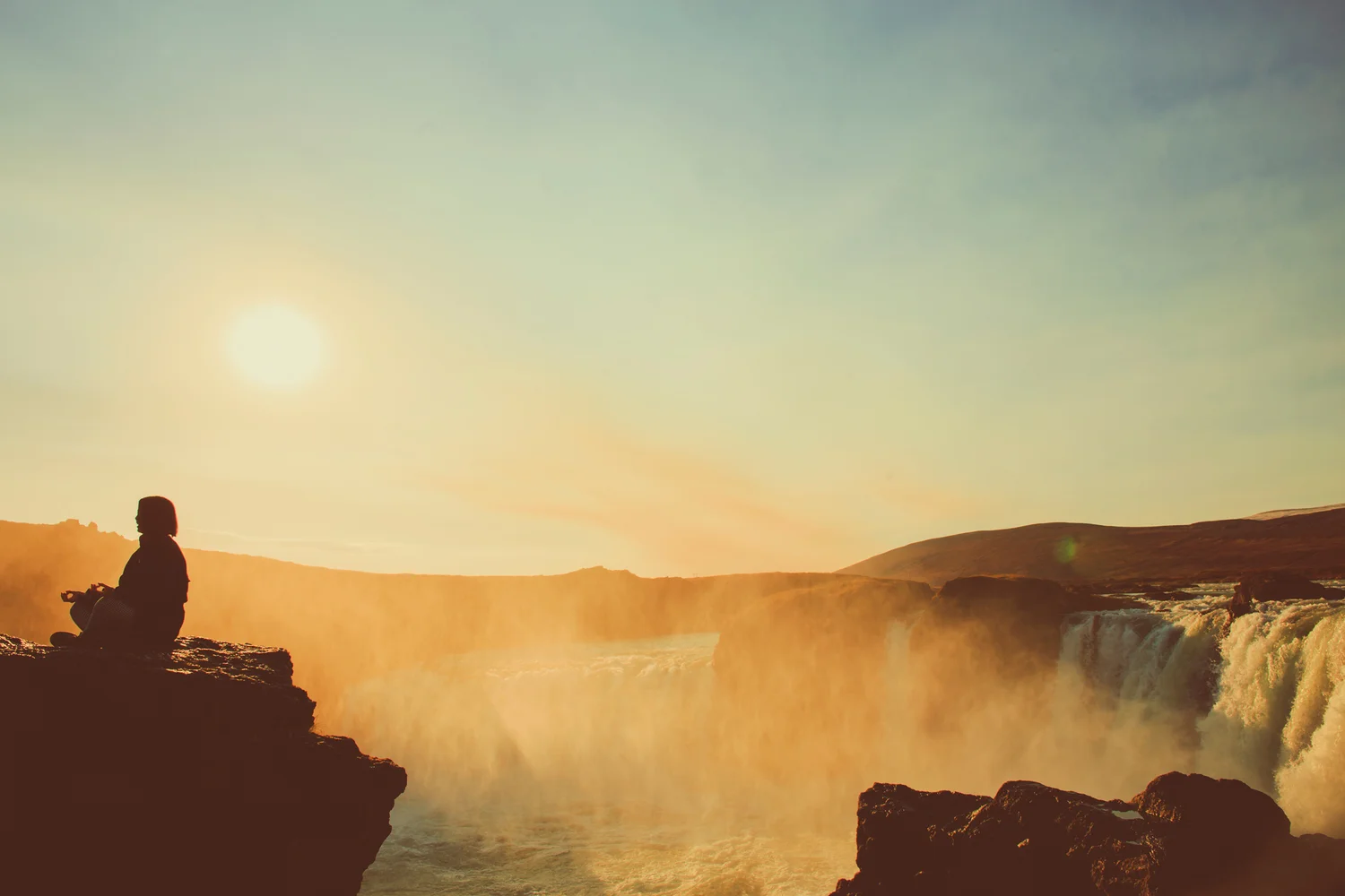 meditator at Goðafoss, Iceland. Photo by Jennifer Picard Photography .