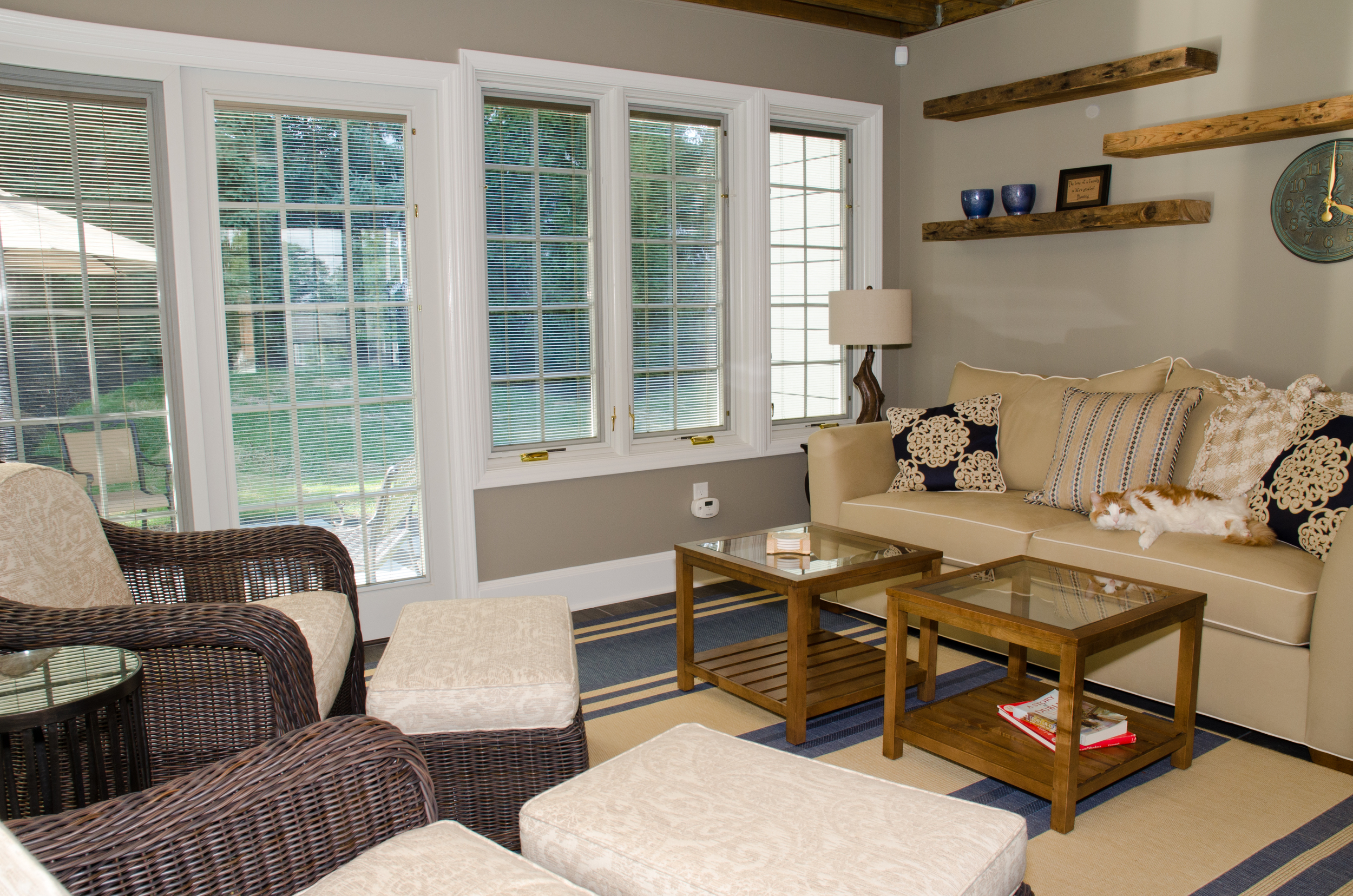 Custom sun room with floating reclaimed lumber shelving. Installation by Groundswell Contracting