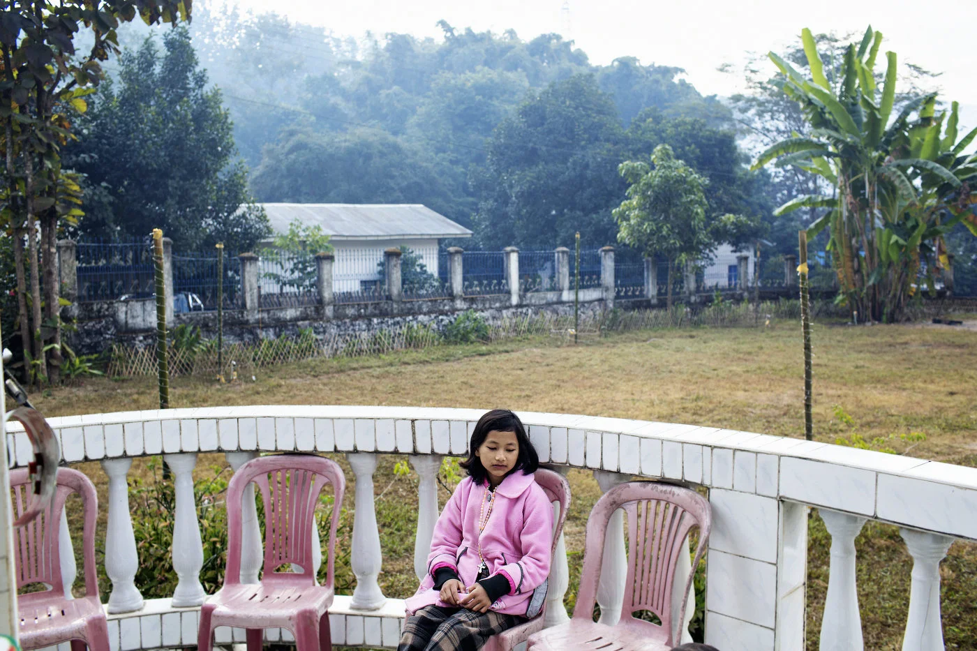 A young girl sit
outside a packed church during mass December 30, 2012 at the Roman Catholic
church in Laiza, Kachin State in northern Myanmar.
