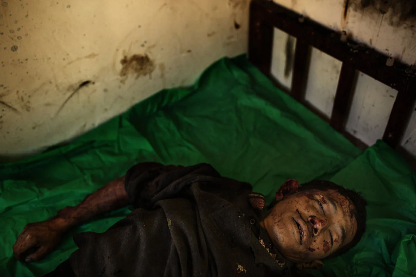 The body of deceased Maji Tu Ja, 40, lies in a mortuary in Laiza Hospital in northern Myanmar. Maji Tu Ja was a farmer and village militiaman who was killed from Burmese Army mortars whilst repairing his tractor in a field. Three other civilians were wounded in the same attack - two of them seriously.