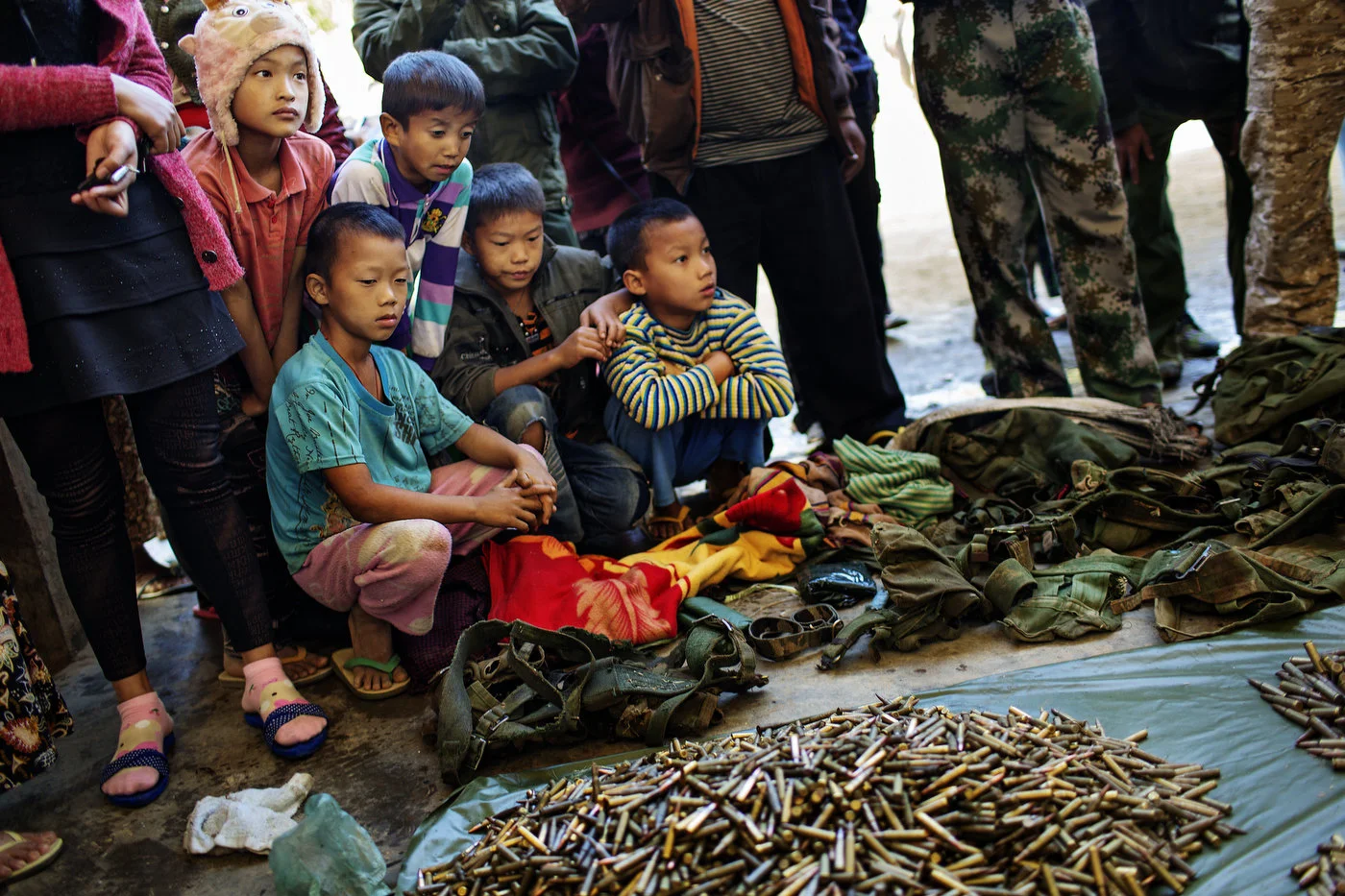 Young Kachin boys
look at ammunition and weapons seized from the Burmese Army after the KIA won a
battle a few days earlier.