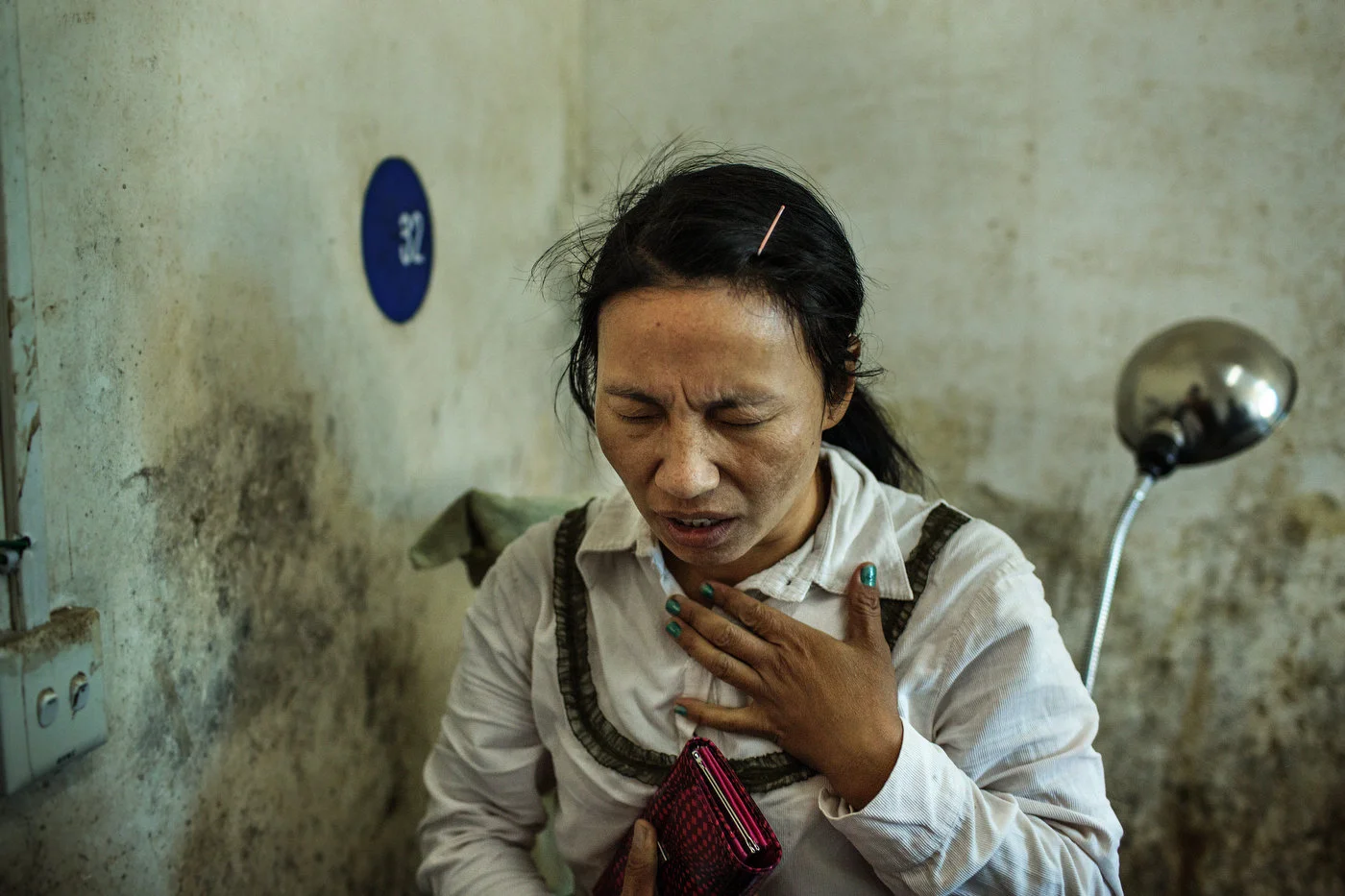 A bigger sister of Lamung Kailing prays while
her little sister is being treated for injuries sustained from mortar shrapnel
in Laiza Hospital.