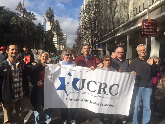 From left, JCRC leaders and friends Ryan Pessah, Muriel Brounstein, Carol Velarde, Bruce Pomer, Choco Leandro Dresser, Bob Dresser, and Dan Weitzman marched in the annual "March for the Dream" parade, which honors the legacy of Dr. Martin Luther King.