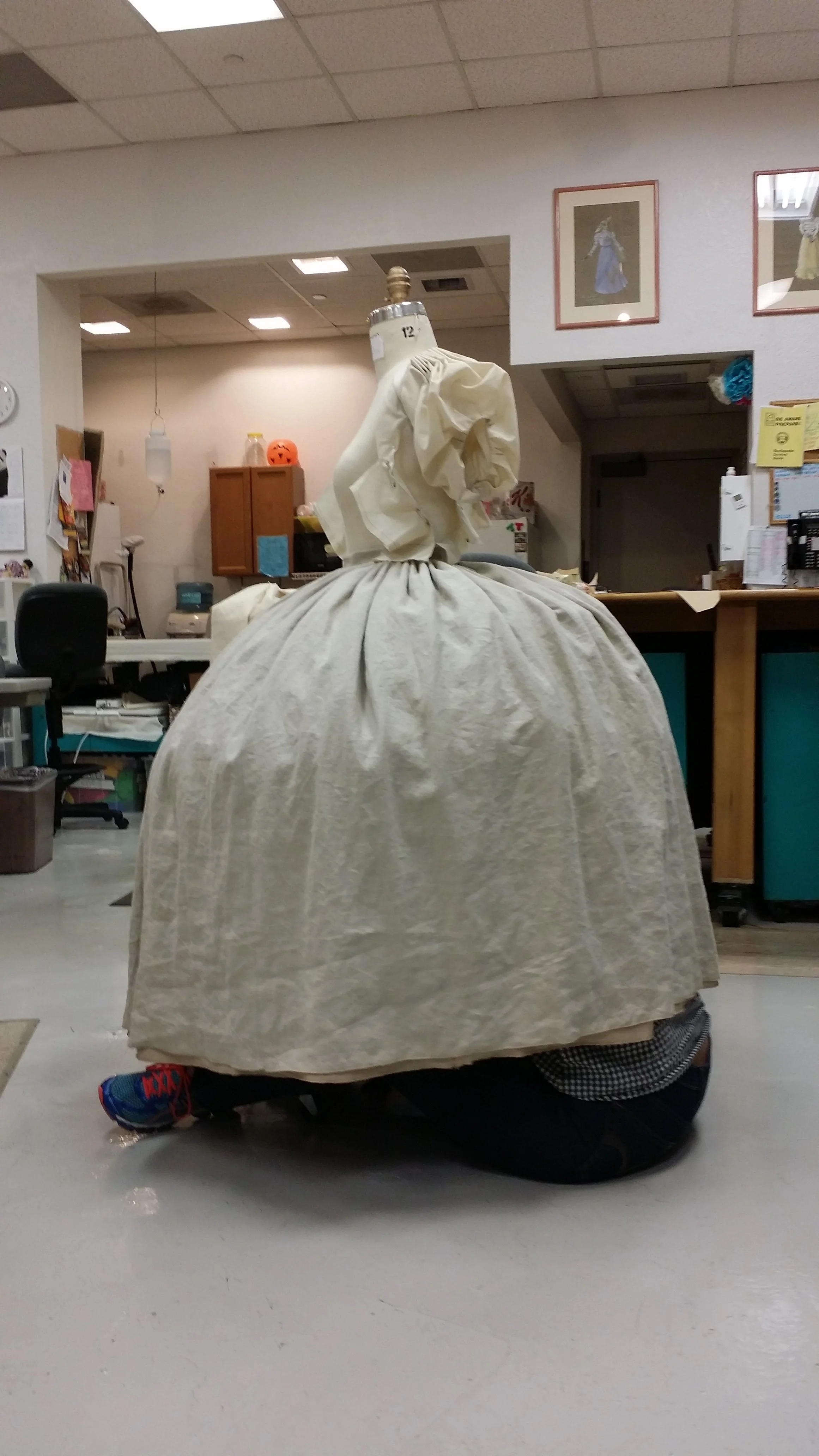 Technician Catherine Esera adjusted the fit of a servant skirt over its petticoat