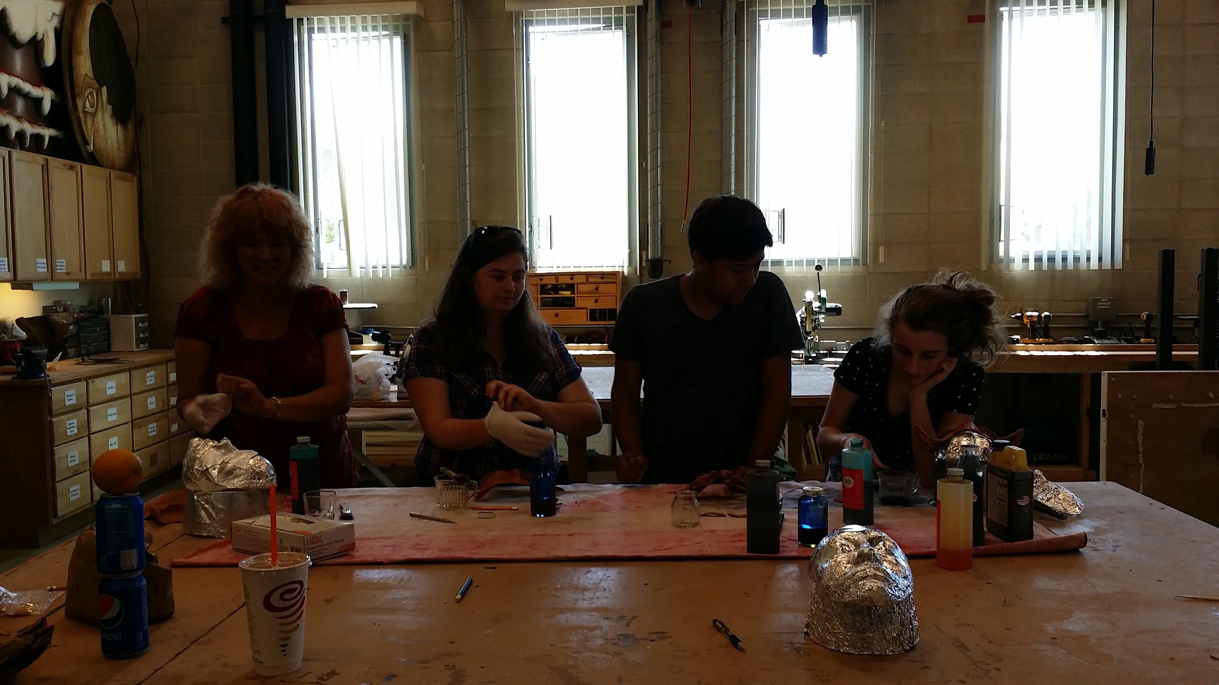 After waiting a day for their masks to dry, the group mixes their dye and stains their final masks. 