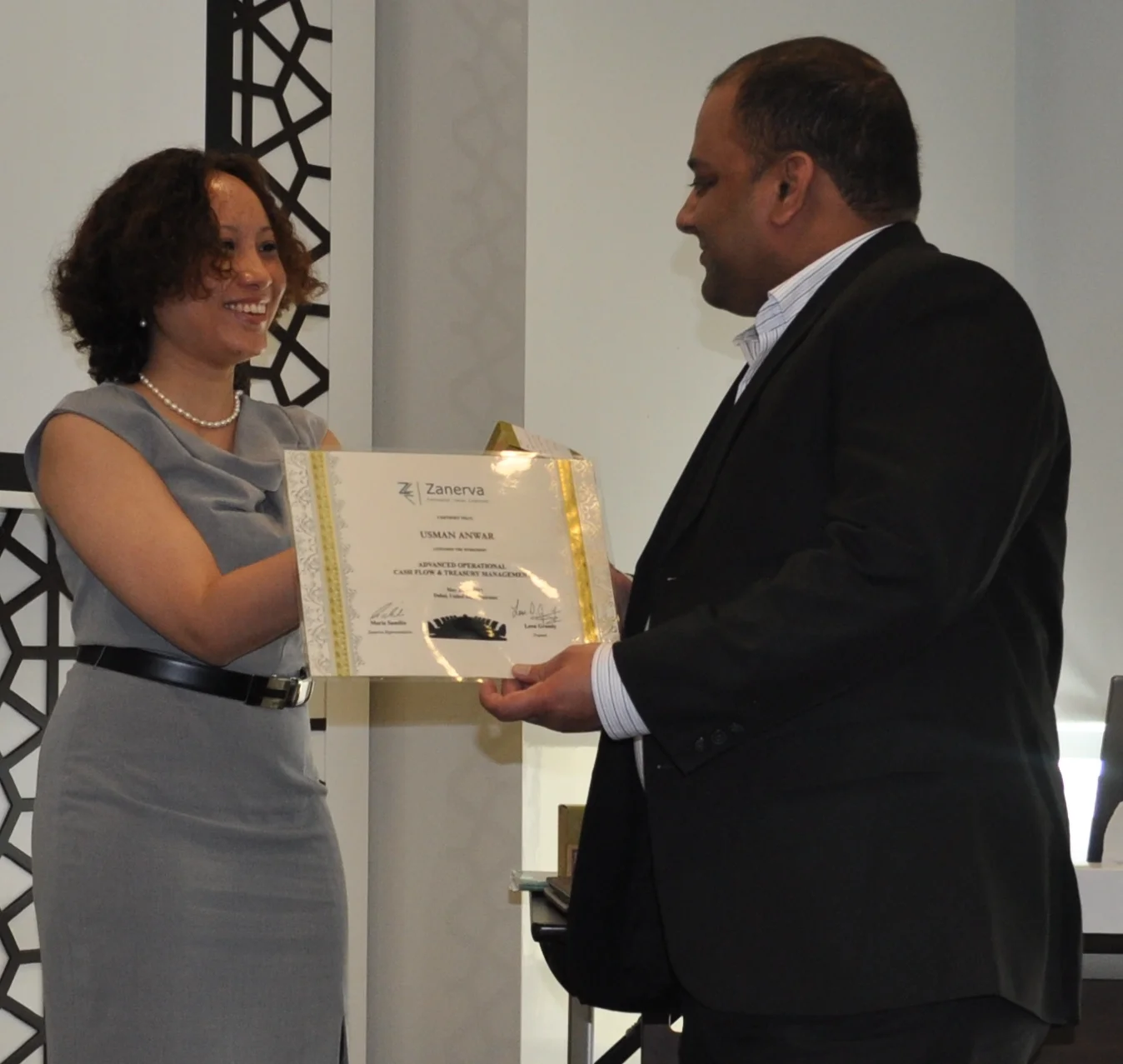 Usman Anwar (Treasury Manager) receiving his certificate of workshop participation from Maria Samilin (Zanerva Director of New Ideas)