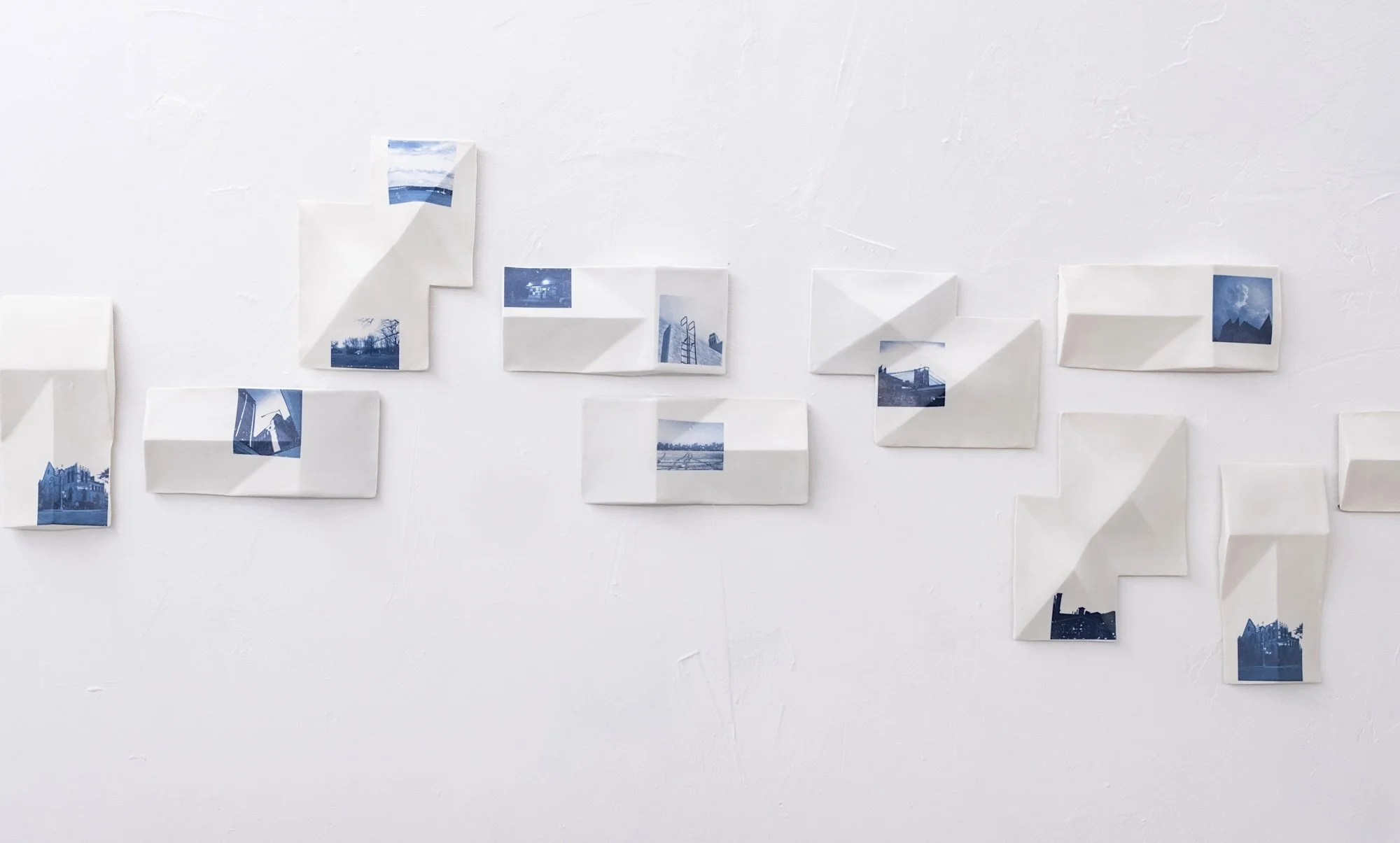 All the Places I (Be)Long 2026. Porcelain and On-Glaze Cobalt Photographic Decals. 
Detail Image.

26” h x 480”w x 1” 