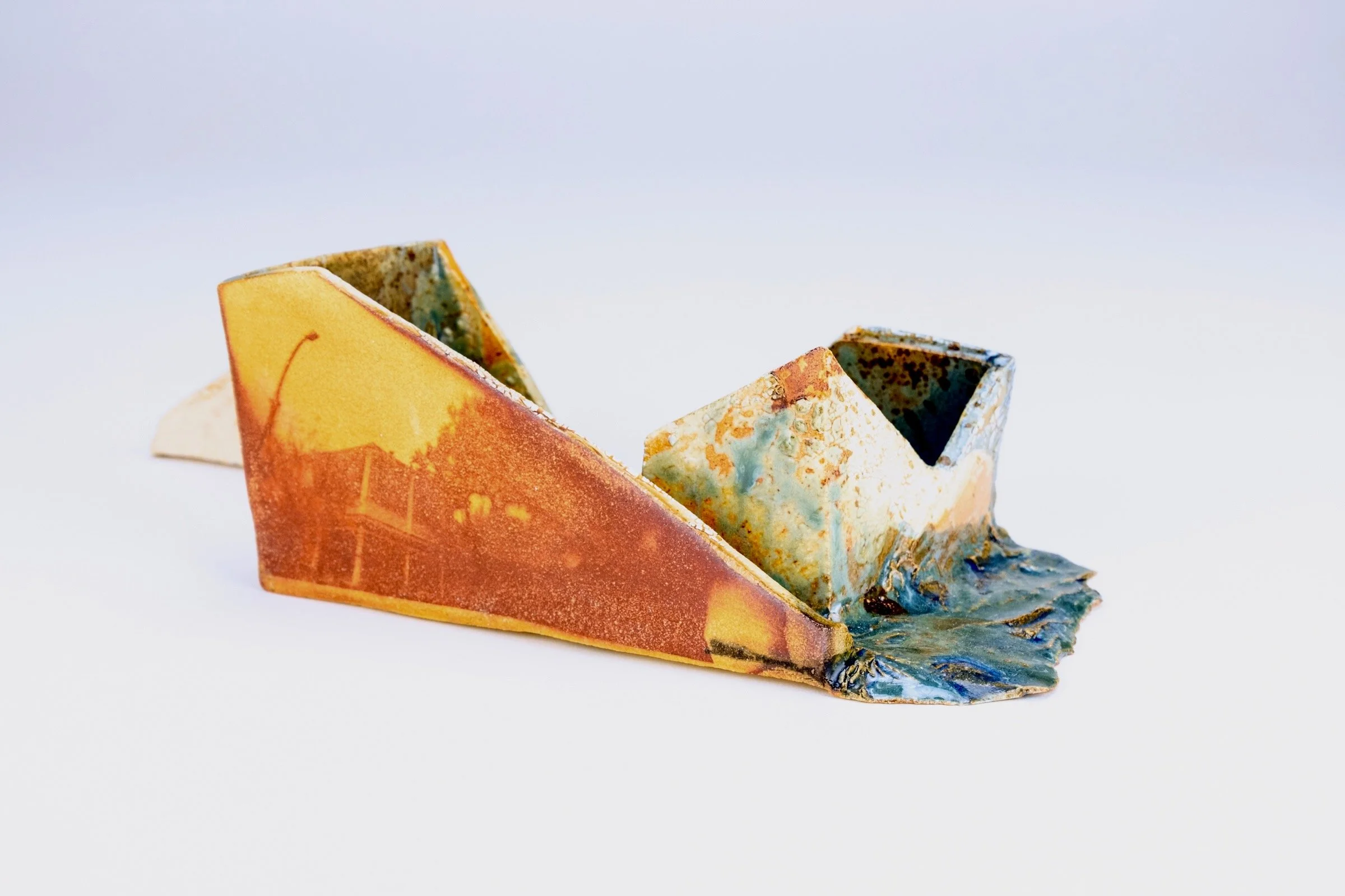 Shifting Memories no.7  2024
Ceramic sculpture with cyanotype image and various glazes.
6” h x 8” w x 5” d