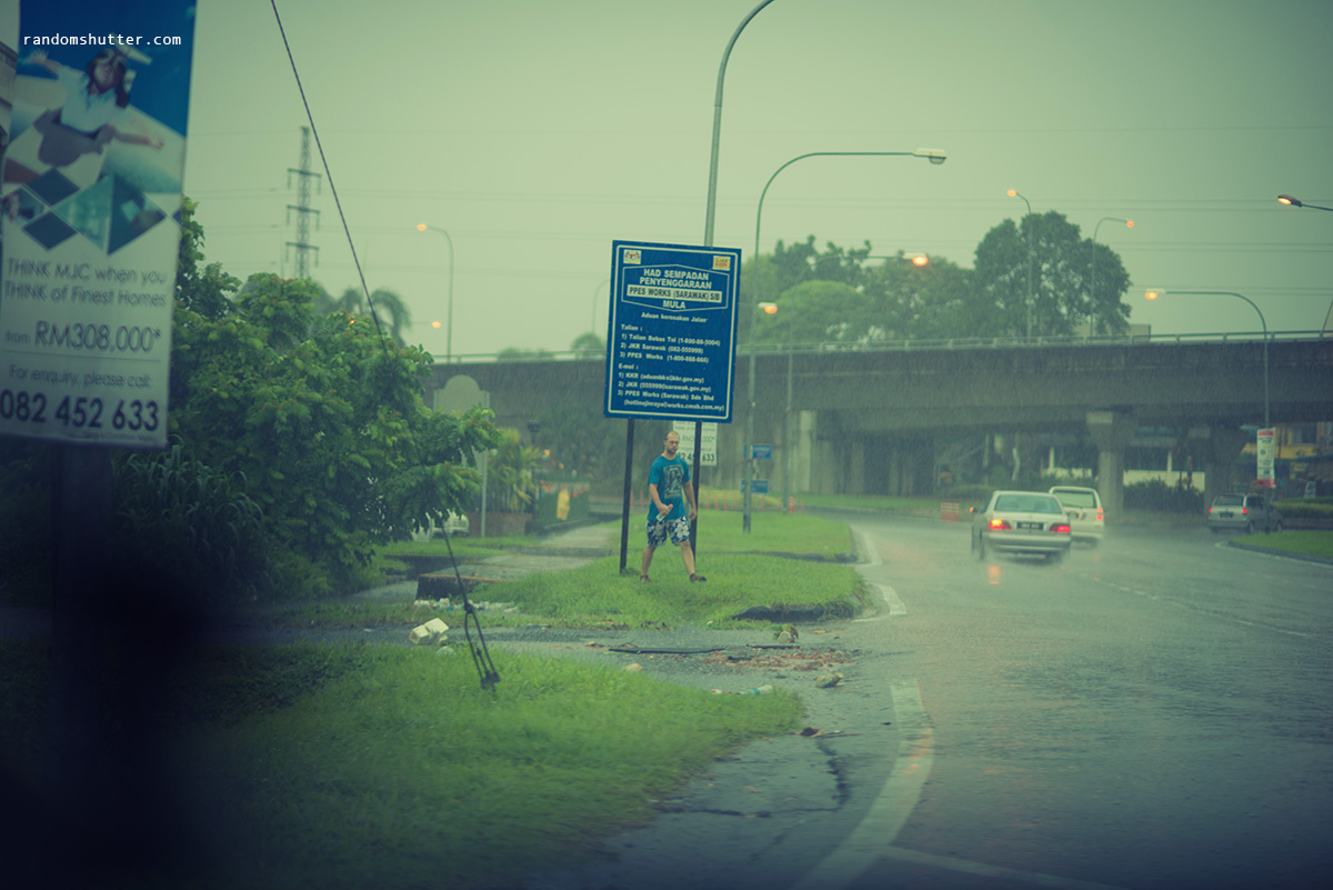 This guy was walking around in the heavy rain, checking out my car as I past