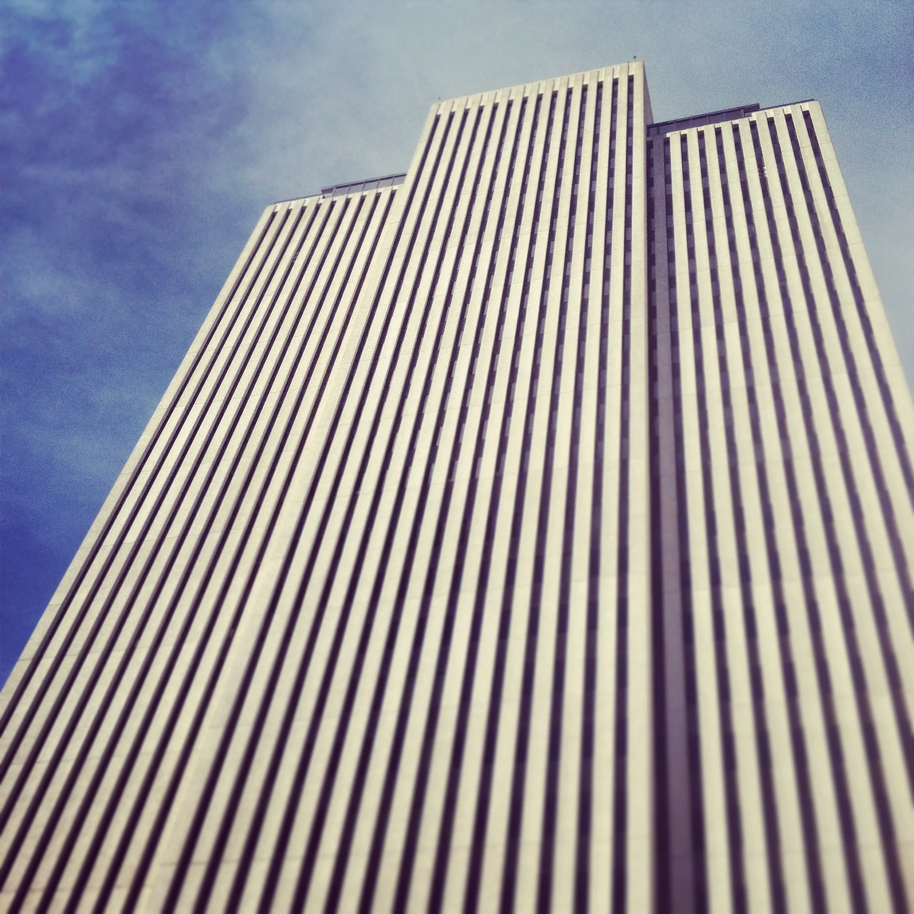 This is the Church Office Building (headquarters of The Church of Jesus Christ of Latter-day Saints). It towers at 28 stories tall and is catty-corner of the Temple. 