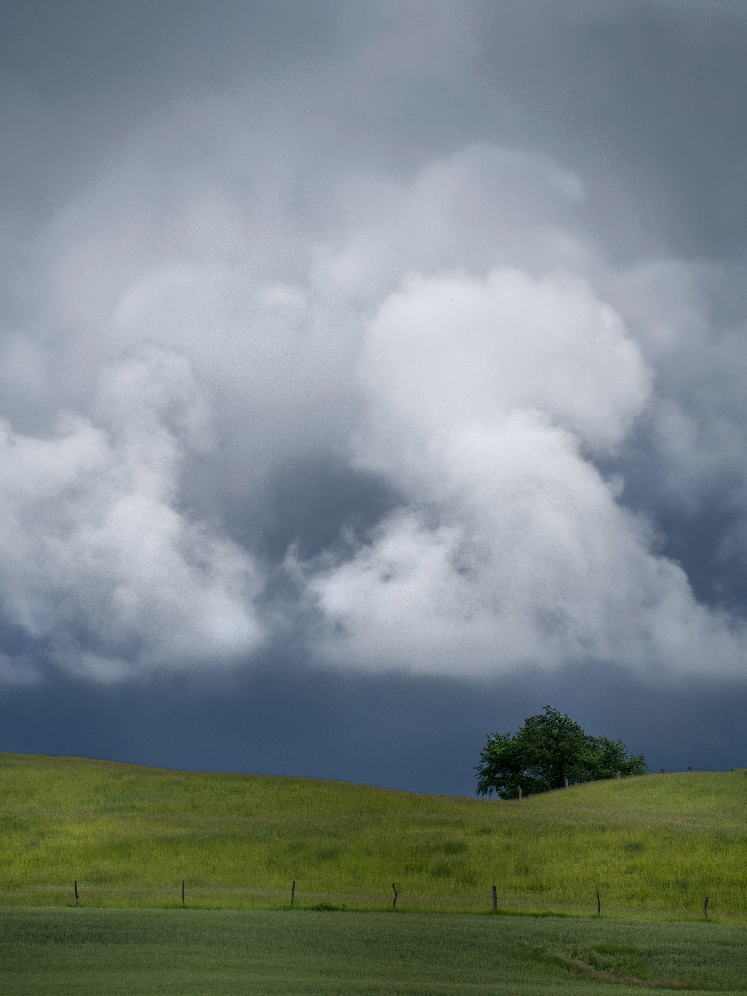 Dark skies,white clouds, and lush green countryside make for a contrast explosion.