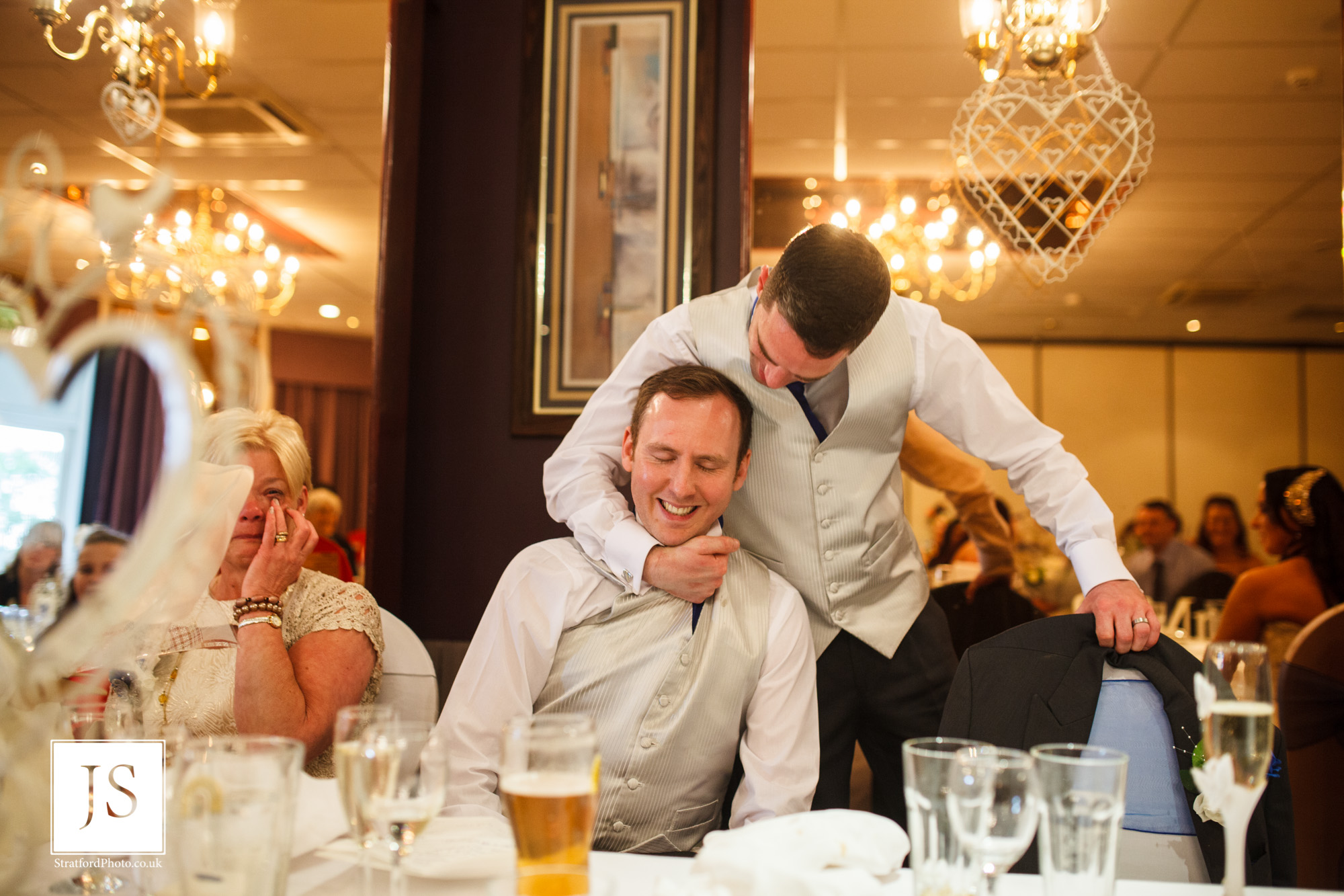 A groom play fights with his best man during his speech.jpg