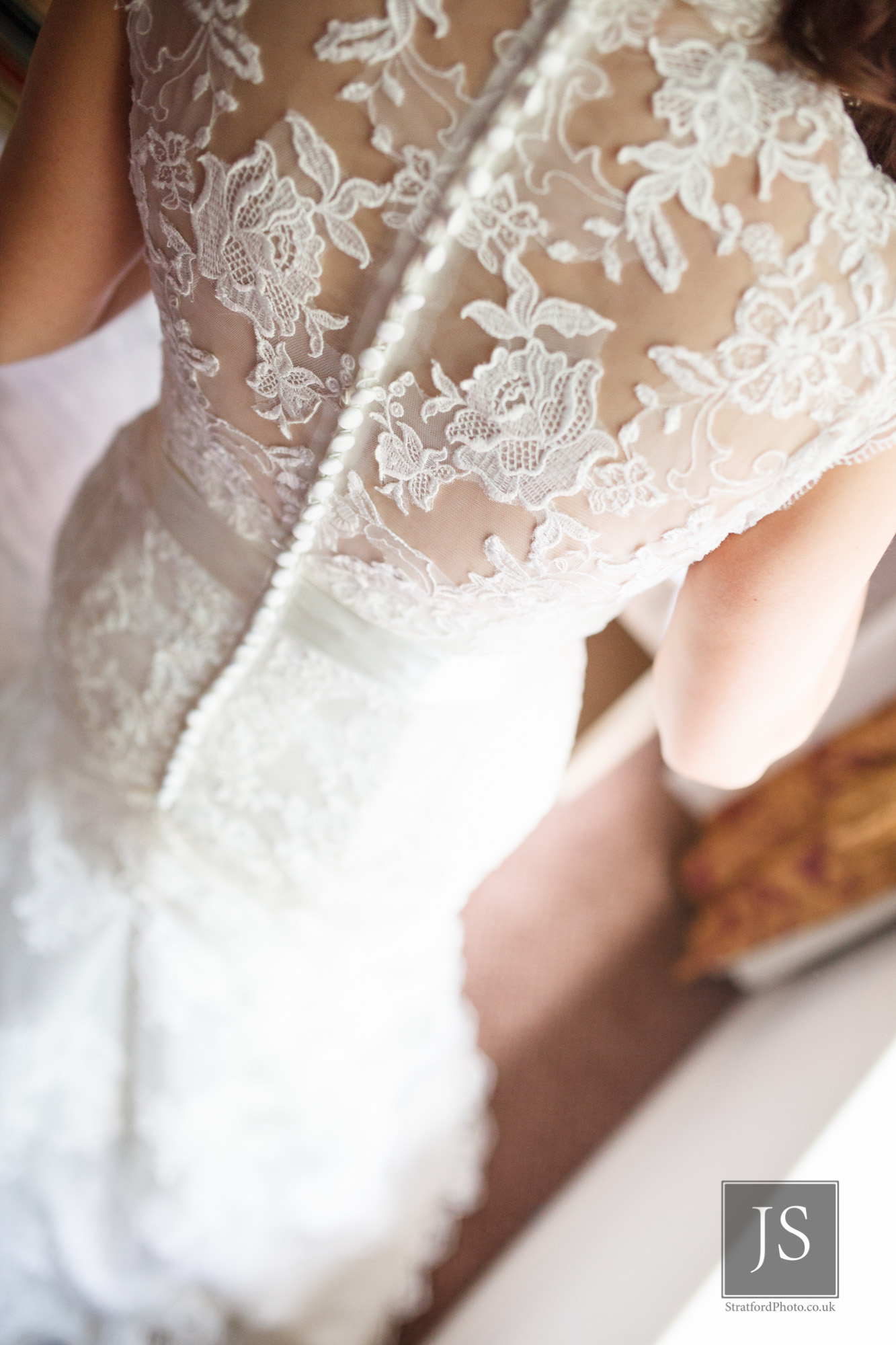 The elegant lace back of a wedding dress.jpg