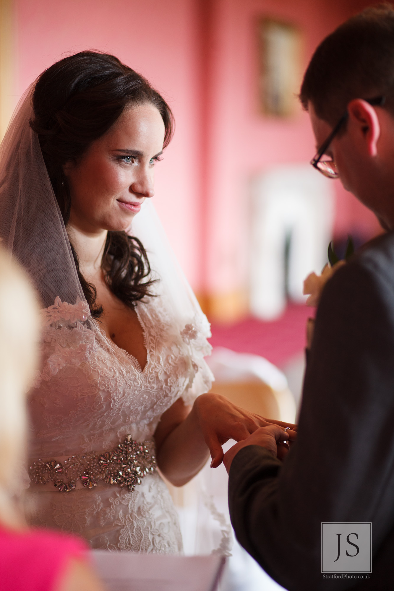 A bride recieves her wedding ring at Haigh Hall.jpg