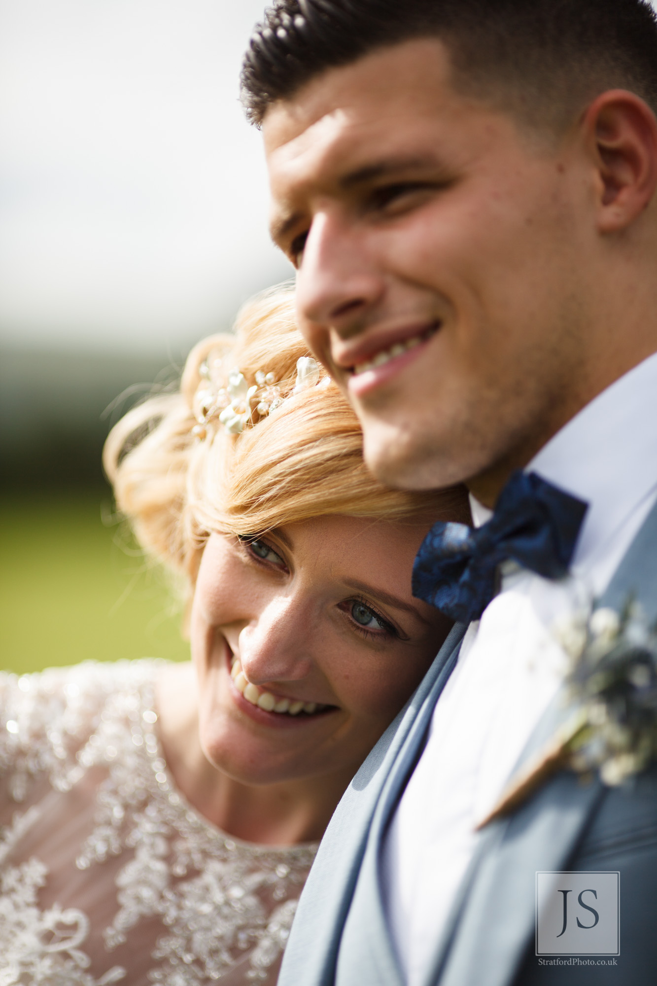 A bride rests her head on her groom's shoulder after the ceremony.jpg