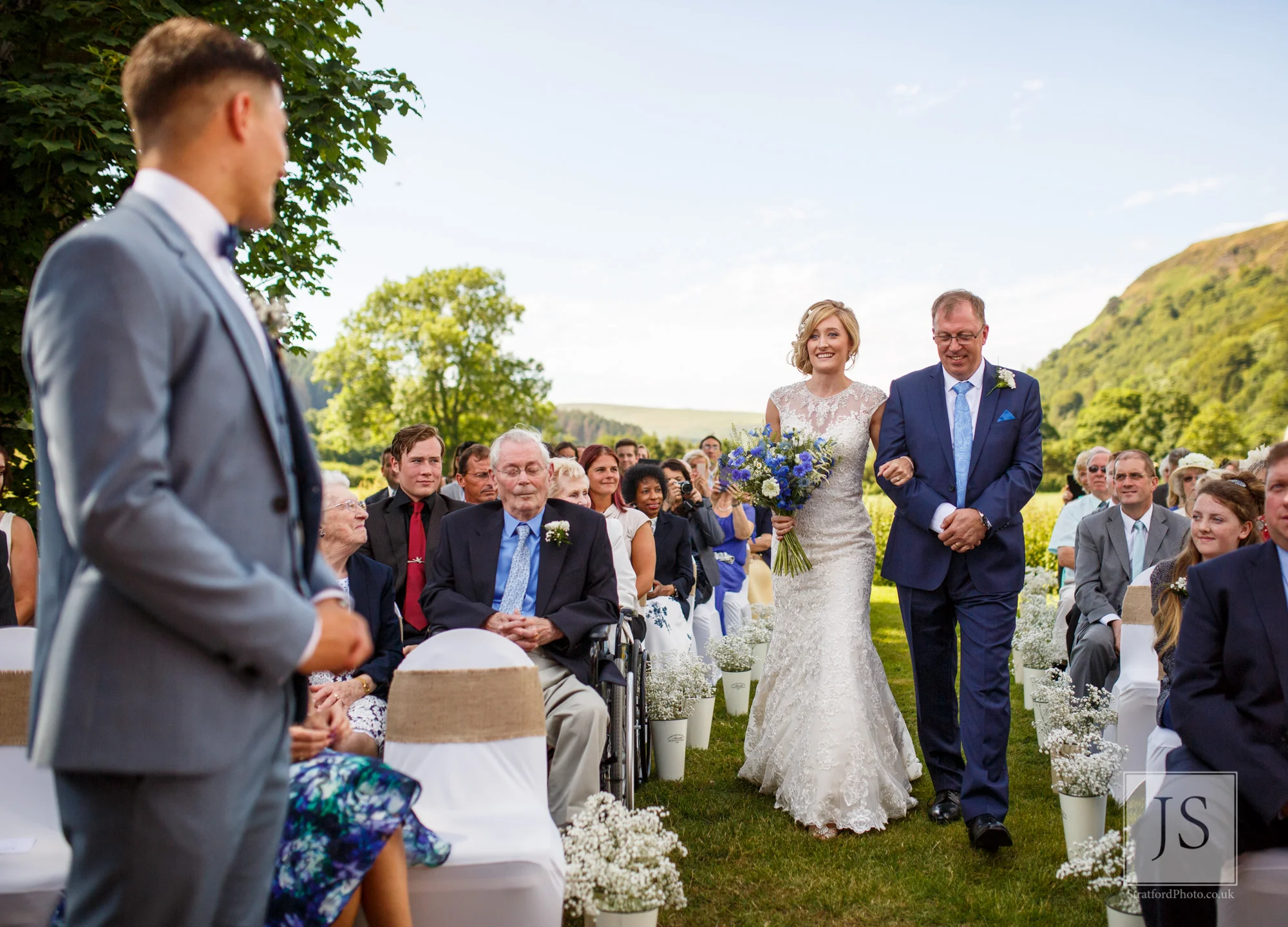 A bride comes down the aisle to her groom.jpg