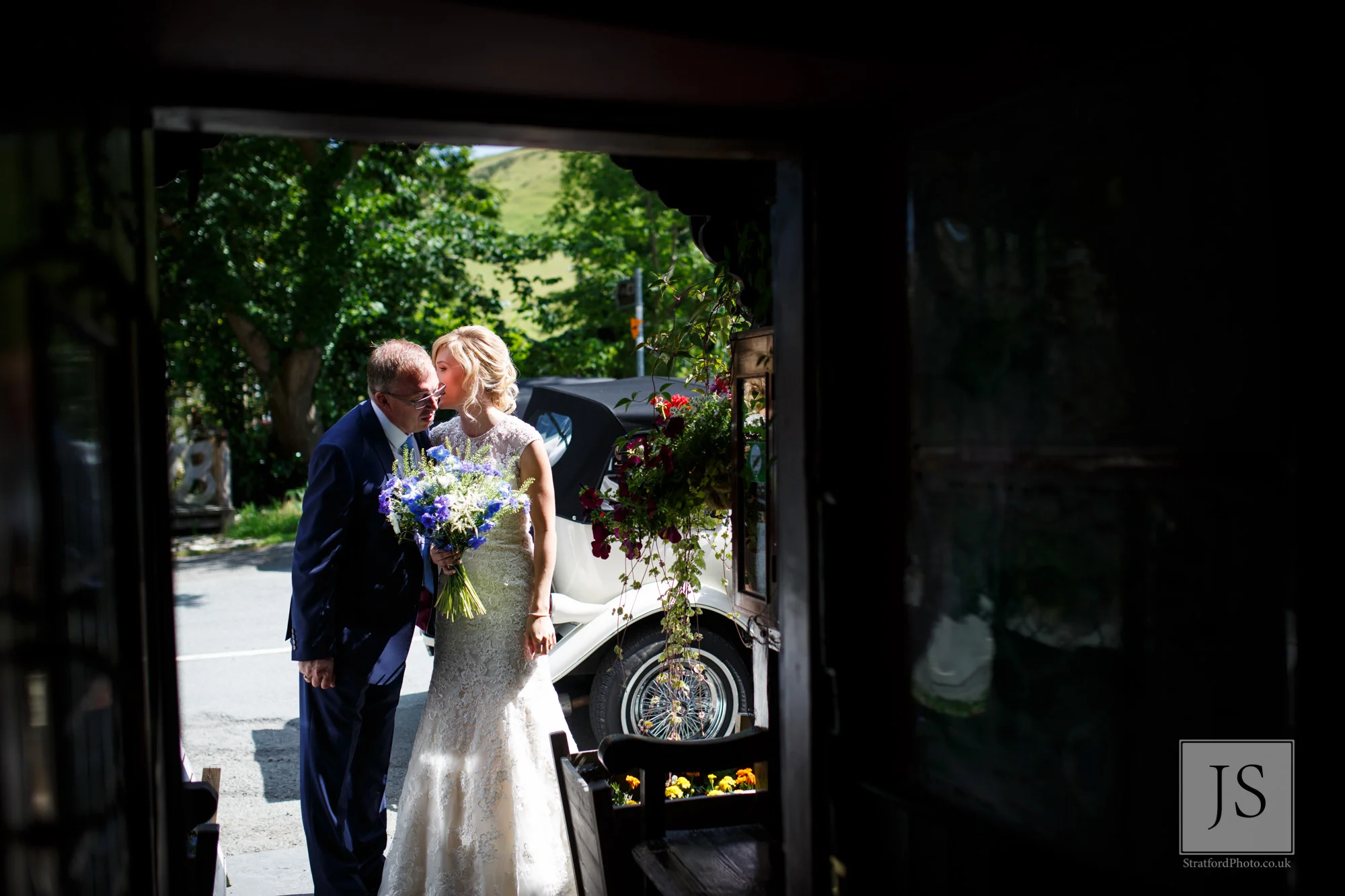 A bride whispers in the ear of her father.jpg