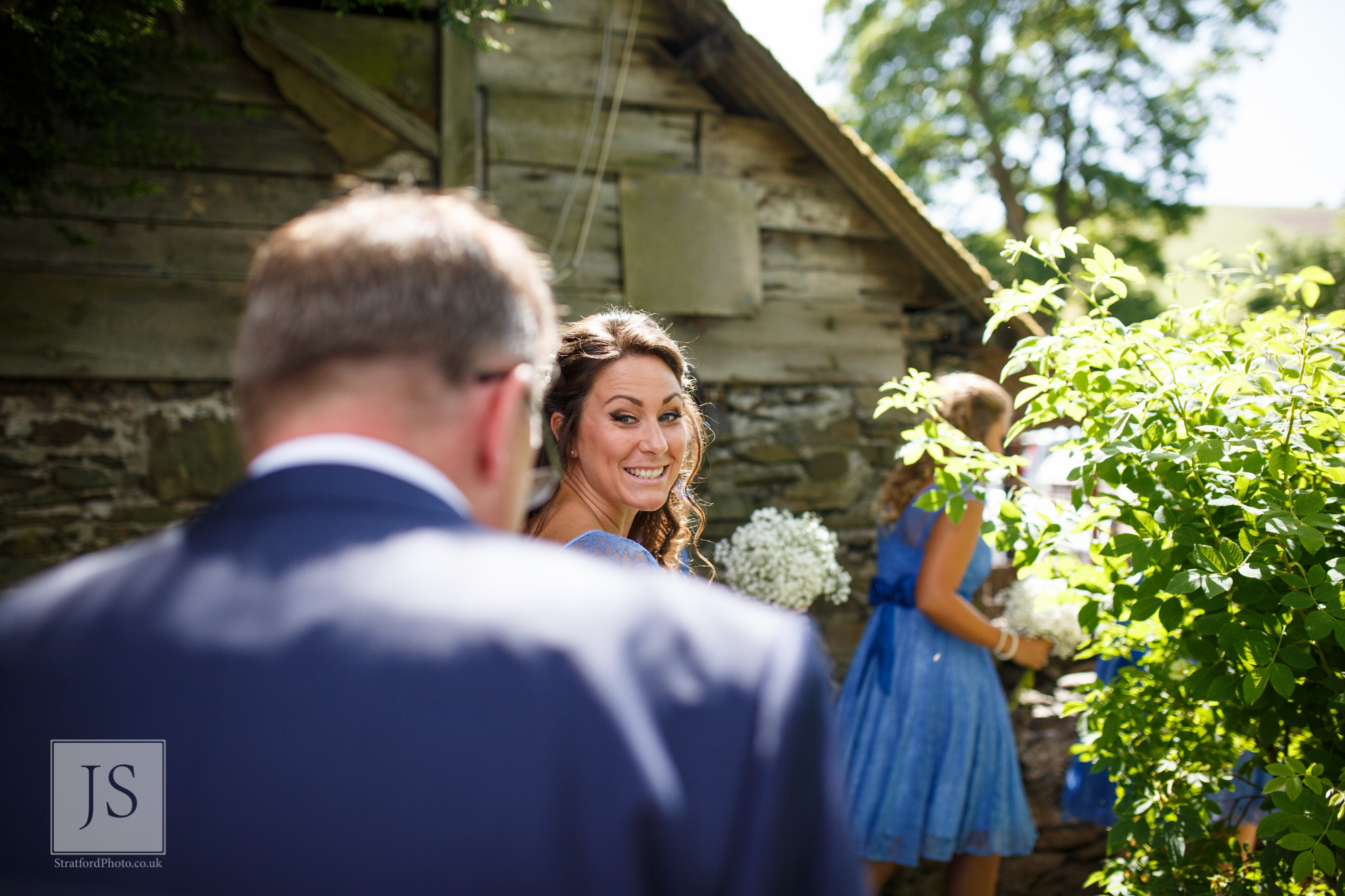 A bridesmaid smiles at her father.jpg