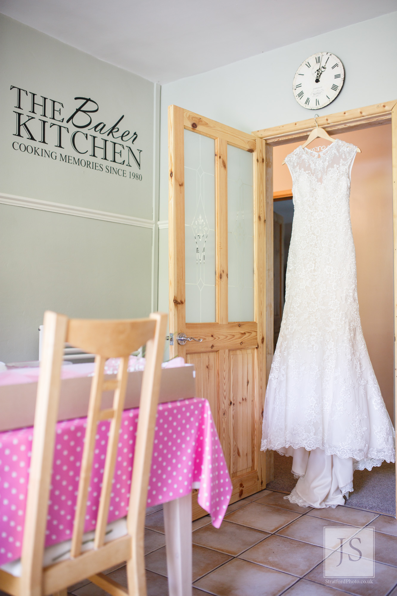 A wedding dress hangs in the family kitchen doorway.jpg
