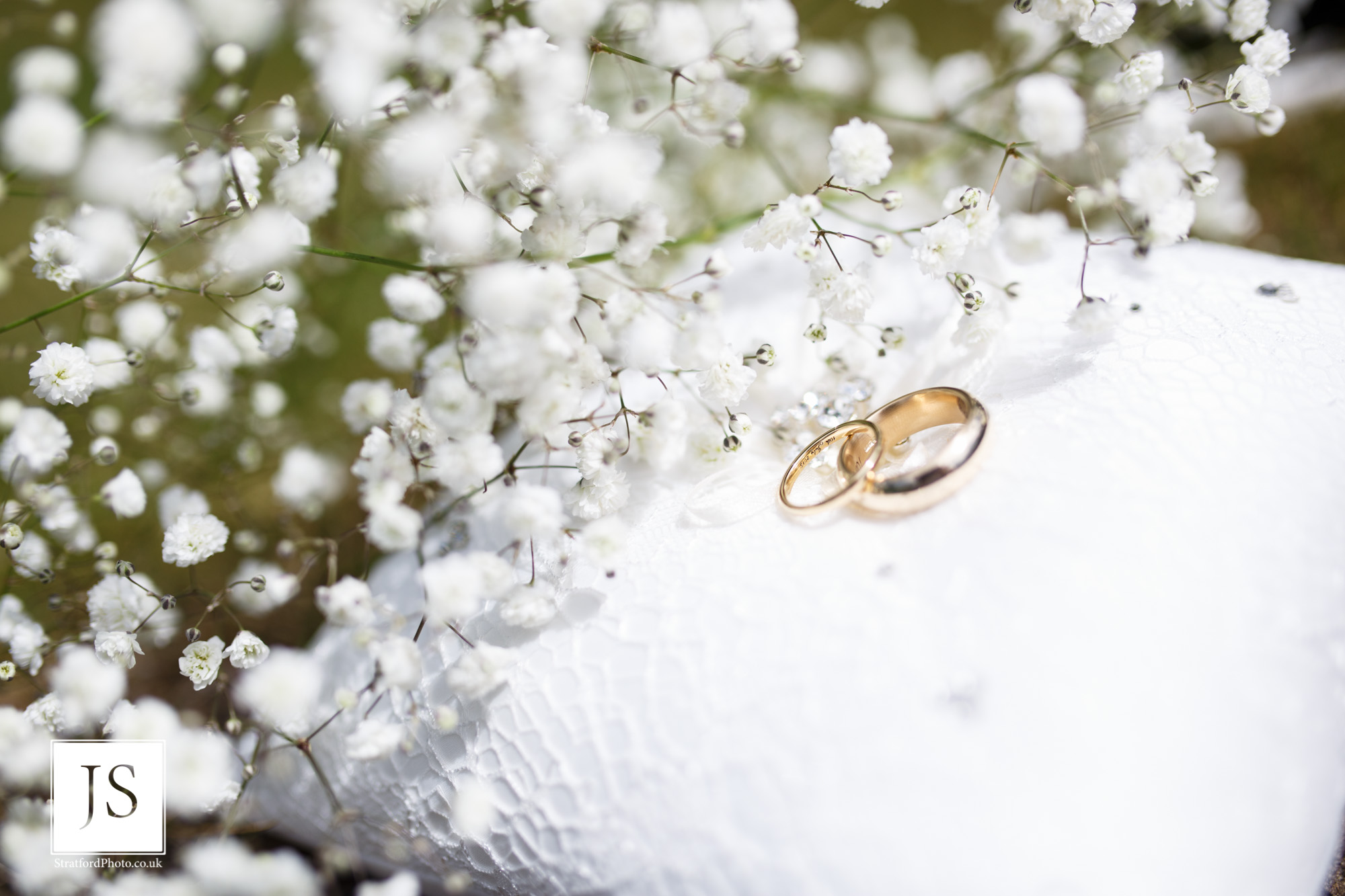 Two wedding rings sit on a cushion waiting for their bearers.jpg