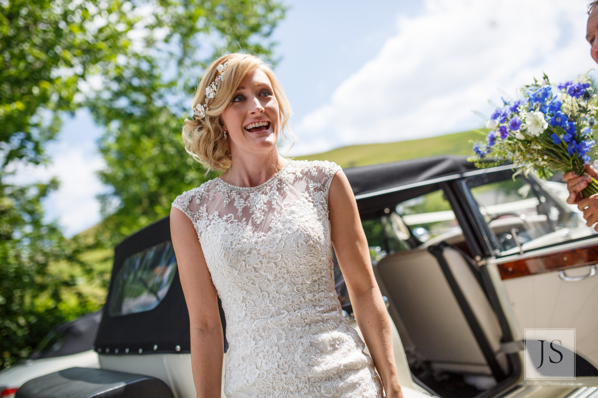 An excited brides gets out of her wedding car.jpg