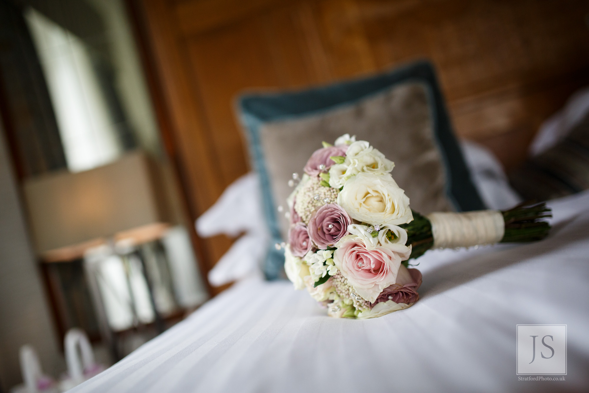 A bouquet of flowers sits on the wedding bed.jpg