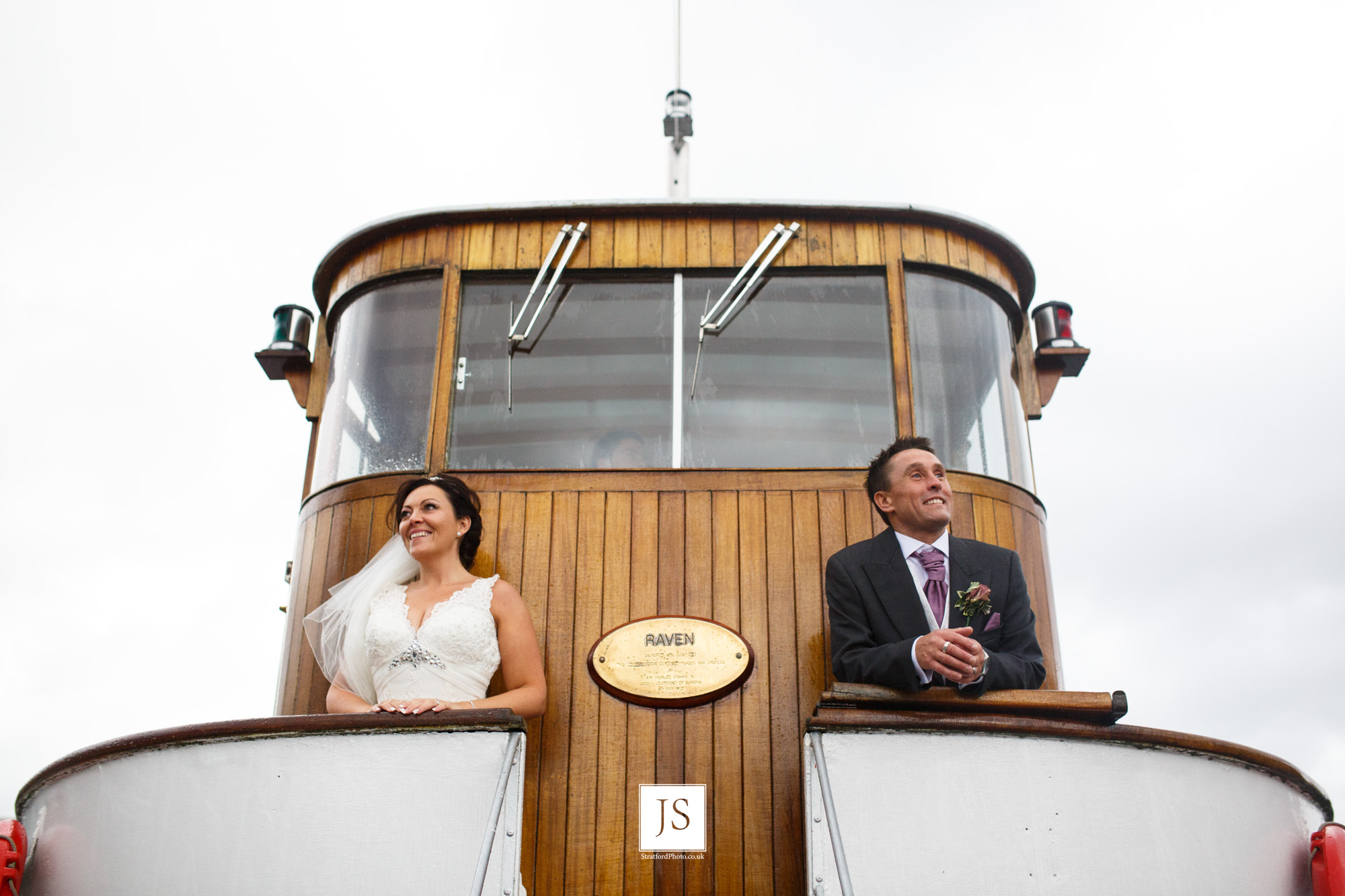 A bride and groom look out from the bridge of a Lake Ullswater steamer boat.jpg