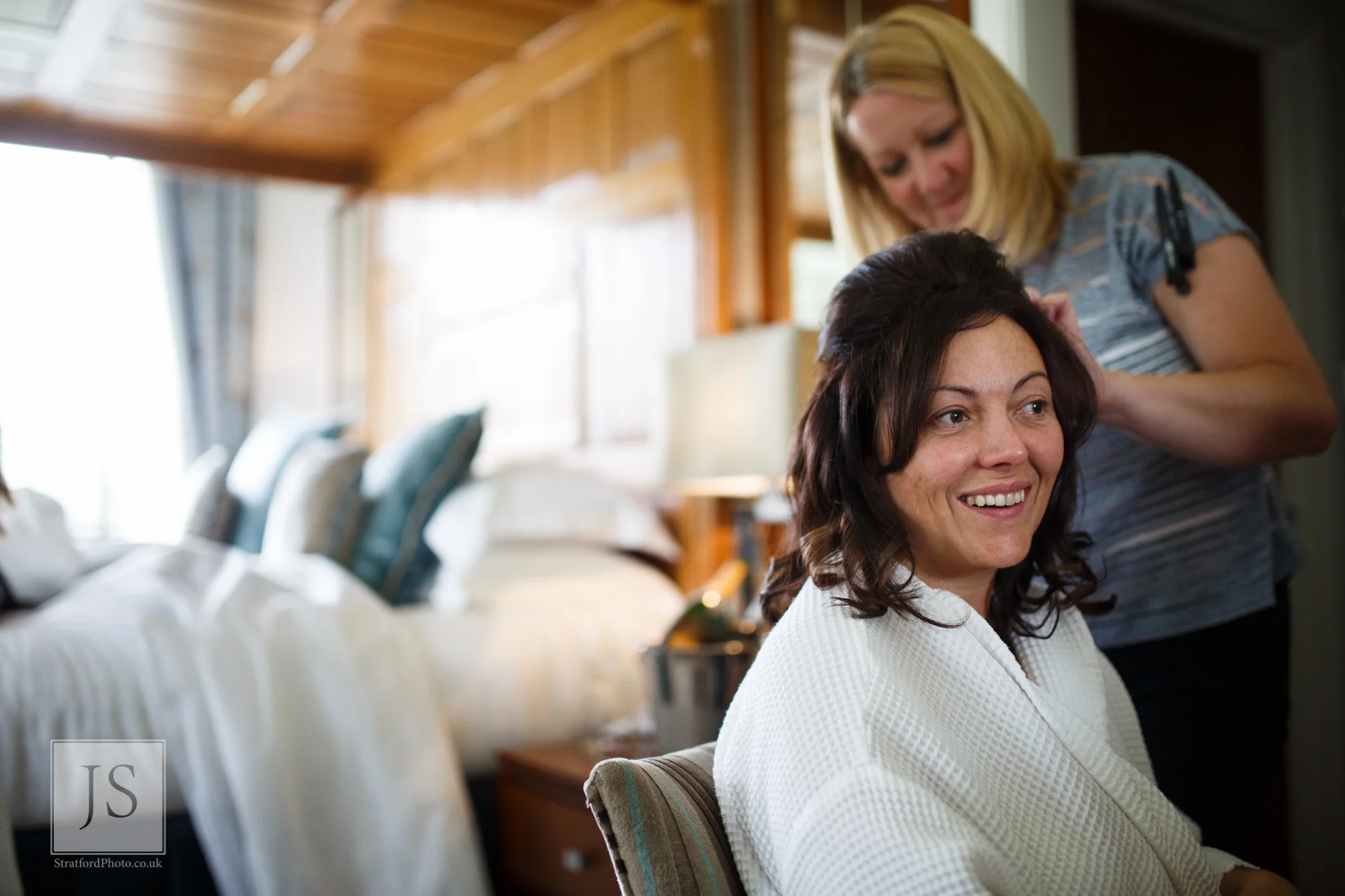 A bride has her hair done on her wedding morning.jpg